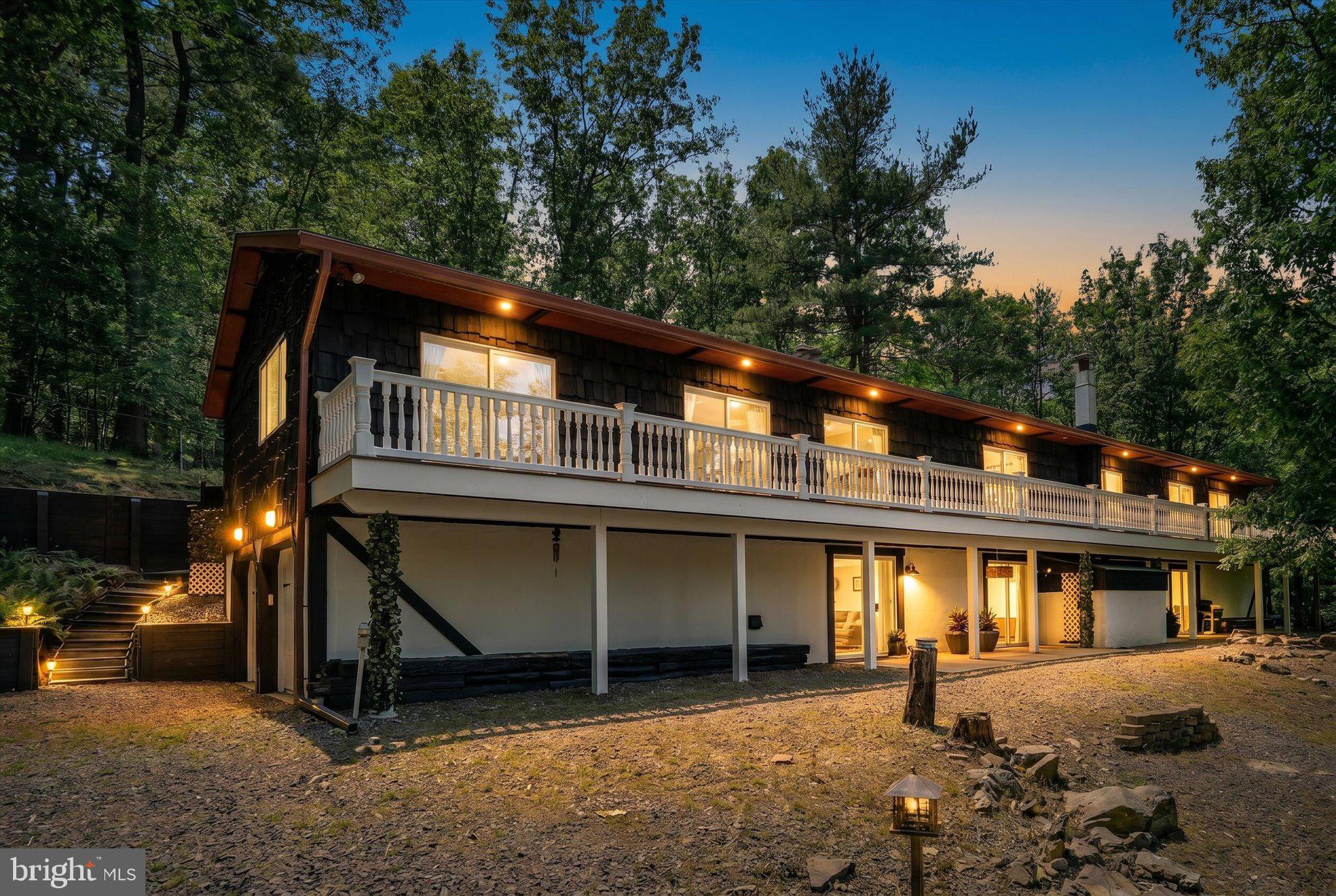 **4 Beds | 3 Full Baths | 4,524 Sq Ft | 1.3 Private Acres**
Welcome to this absolutely stunning, one-of-a-kind California-style raised ranch — a true masterpiece nestled among spectacular forestry on 1.3 private acres. This renovated gem blends craftsmanship with character at every turn. The main level showcases three gorgeous bedrooms and two full bathrooms, a welcoming slate foyer entrance, library, living area, and dining space flowing across contiguous pine, cedar, and oak flooring. Custom built-in bookshelves, elegant crown molding, and inviting neutral tones elevate the feel of this extraordinary home. Each bedroom features newer Pella door access to the private solid PVC deck with white vinyl railing overlooking tranquil wooded views. A brilliant opportunity awaits the custom craftsman ready to finish the kitchen and one bedroom to personal taste — commercial refrigerator included. Two stunning wood fireplaces — one marble, one stone — anchor the home with warmth and elegance. The fully finished basement delivers a fourth bedroom, full bathroom, and complete kitchen, perfectly suited as an in-law suite or extended living quarters. Outside, enjoy a fenced backyard, two driveway entrances, and a two-car attached garage with electric openers. Notable upgrades include a top-of-the-line Elk roof installed in 2012, copper chimney re-flashing, heat pump and central air, dual function furnace, newer gutters/downspouts, and 55 PSI steel beam construction. Conveniently located near B Dock park, this property offers privacy, potential, and unmatched charm. All window treatments, appliances, and TVs convey with sale. Priced accordingly, this beauty is being sold in its present condition, allowing the new owners to customize finishes to their personal taste.
Lake Wynonah is a gated community featuring 2 freshwater lakes (at capacity, *Lake Wynonah is approximately 90 ft. deep and Fawn Lake 45 ft. deep at deepest areas). Amenities can include: business office/gathering room/library, lodge w/dining and bar, social clubs, boating, fishing, wakeboarding, waterskiing, tubing, paddleboarding, tennis, pickleball, several parks/pavilion, basketball courts, horseshoe pits, outdoor pool, beautiful docks, hiking, natural wildlife and marina. Groups and events include: Active Civic Association, Dances/Concerts, Book Group, Pinochle Group, Volunteer Programs, Fish & Boat Group. Located an hour or less from Allentown, Harrisburg, Hershey and Reading. Close to Philadelphia and surrounding suburbs. Beat the beach traffic and settle in at the lake. Lake Wynonah is "Life On Vacation"! *Agents/Buyers please call the Lake Wynonah Business Office for updates regarding the Lake Wynonah dam rehabilitation project and potential future assessment. Dam slide presentation and HOA information available in Documents.