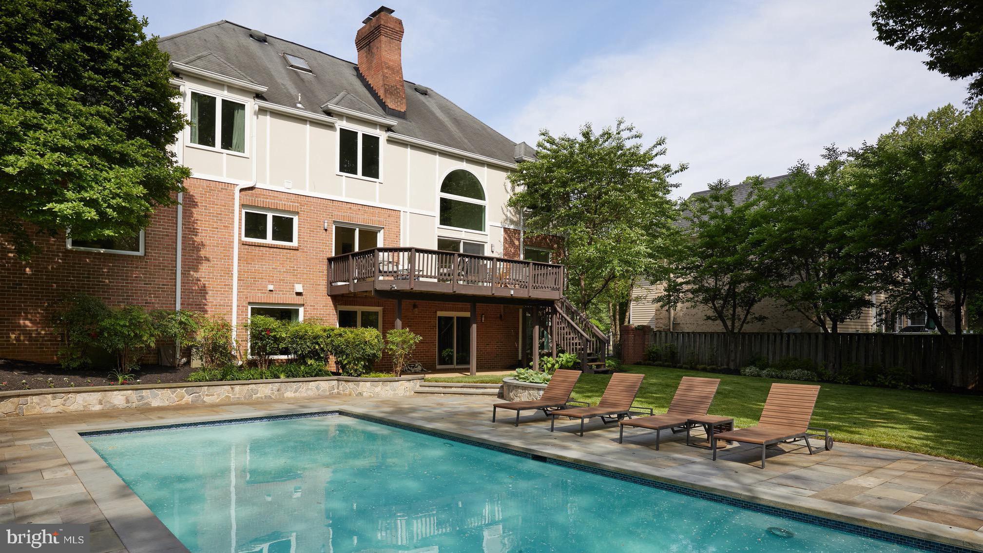 AMAZING LOCATION ON A QUITE CUL DE SAC WITH SWIMMING POOL! This elegant six-bedroom, five-and-a-half bathroom residence offers a private retreat that's only minutes away from DC and VA. Located on three levels, you'll find handsome hardwoods throughout. The centerpiece of this home is the newly renovated gourmet kitchen designed by Bulthaup featuring Miele appliances with gas cooktop and double oven. The family room features two-story vaulted ceilings, expansive windows and contemporary fireplace.The separate wet bar with two-drawer refrigerator and wine cellar make this an entertainer's dream. Open the sliding doors to the deck and experience the beautifully landscaped backyard. The main level also includes a formal living room with fireplace, dining room that's right off the kitchen, office, powder room and guest bedroom with en suite bath. On the upper level, you'll find a sitting room with another fireplace, which leads to the spacious primary bedroom with huge walk-in closet and en suite bath that boasts a dual vanity, deep soaking tub and glass enclosed stall shower. On this level, there's also a second bedroom with en suite bath, two additional bedrooms that share a bath and a dedicated laundry room. Venture to the lower level and you'll find a recreation room, exercise room with sauna, a sixth bedroom, bathroom, two spacious storage closets with shelving and the pool service room. There's also access to a two-car garage that offers shelving and a separate work room. Outside, in addition to the deck on top, you'll find a patio that leads to the brand-new swimming pool outfitted with four luxurious teak lounge chairs. With its style, location and privacy, this residence is definitely the one you've been looking for!