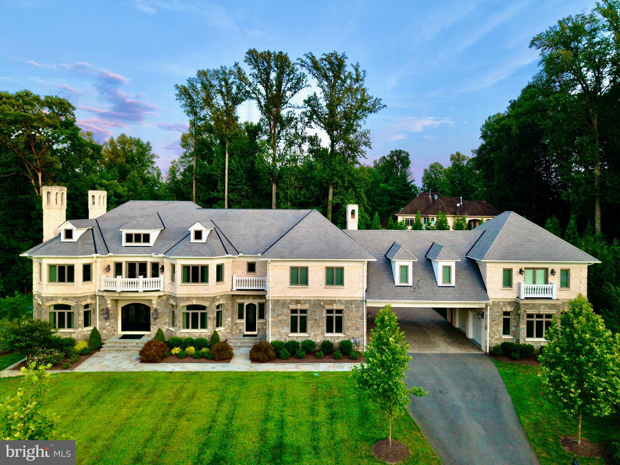 Discover the epitome of luxury and elegance at 1039 Aziza Court, a magnificent estate located in the prestigious area of Great Falls. This stunning property, set on approximately 2 acres of beautifully landscaped grounds, offers an almost 15,000 Sq Ft seamless blend of timeless design and masterful craftsmanship, perfect for those seeking a sophisticated lifestyle.
GRAND INTERIORS:
Upon entering this luxurious home, you are welcomed by a sweeping foyer featuring 2 grand crystal chandeliers. The soaring ceilings adorned with intricate crown molding add to the home's sophistication and grandeur. 
GOURMET KITCHEN HAVEN:
The state-of-the-art gourmet kitchen is designed for culinary enthusiasts. It boasts a 60-inch Wolf Range with double ovens, a griddle, and a pot filler water tap. The kitchen is equipped with two hammered copper farm sinks, two Miele dishwashers, and a built-in microwave, offering ample space for multiple chefs to work simultaneously. Custom cabinets and a smart layout make culinary experiences both easy and delightful.
LUXURY PRIMARY SUITE SANCTUARY:
Retreat to the tranquility of the primary suite, a private haven featuring a generous seating area, a cozy two-sided fireplace, and a retreat kitchen area with refrigerator. The lavish ensuite bathroom is designed for ultimate relaxation, with heated marble floors, a two-person spa, Kohler steam shower, and separate his-and-her sink areas. Step onto the private terrace off of the master suite to enjoy stunning views of the tranquil lush gardens.
OUTDOOR PARADISE
Experience the ultimate outdoor paradise with four fireplaces, a pizza oven in the outdoor kitchen, and an Olympic-sized pool with a bubbling spa. The outdoor area is perfect for alfresco dining and entertaining year-round. Enjoy the basketball court, which easily converts to a pickleball court, and a beautifully landscaped garden with 31 point irrigation and lighting systems.
MODERN CONVENIENCES
This smart home is equipped with "Savant," allowing you to control lighting, TV, music, indoor gas fireplaces and shades effortlessly. A Tesla charger is available, and state-of-the-art exterior infrared camera security system features provide peace of mind. The full house generator ensures uninterrupted comfort and convenience no matter the weather or circumstance.
Community and Neighborhood

Great Falls offers charm, exclusivity, and top-tier amenities logistically situated in the heart of Northern Virginia and 30 minutes from Georgetown, DC. Located within the renowned Langley High School district, known for its academic excellence, this property combines serenity with access to Northern Virginia's vibrant community and resources.