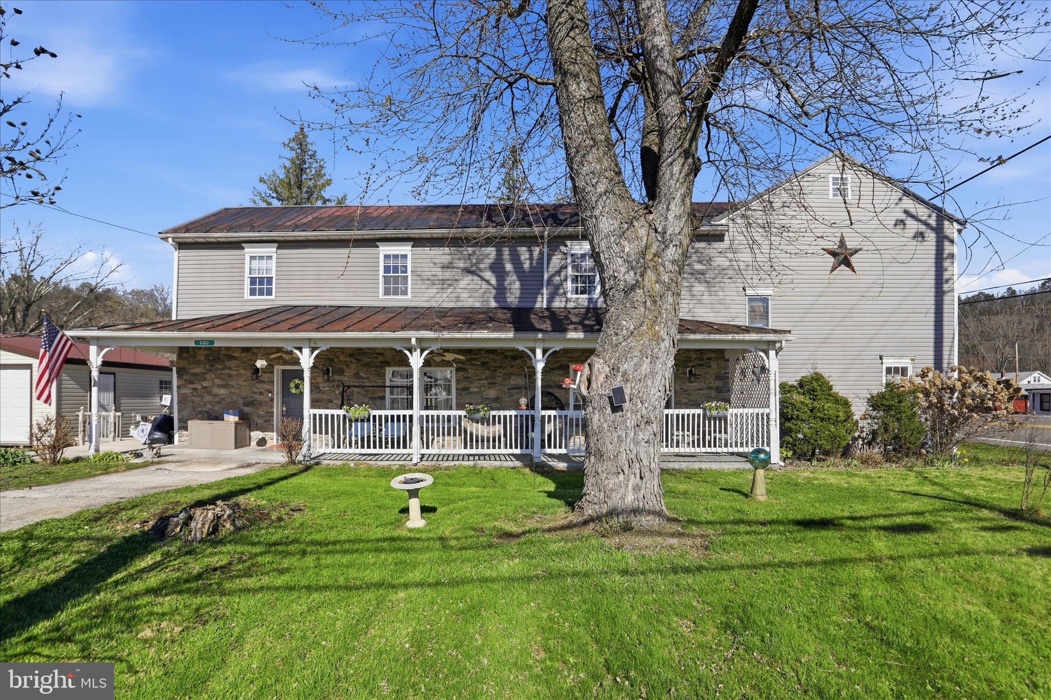 Step back in time with this stunning colonial-style home, built in 1837 and full of character, located in Springfield, WV in Hampshire County. The impressive stone front and expansive covered porch set the tone for this one-of-a-kind property.

The main level offers a spacious layout with a separate dining room, family room, and living room, along with a well-appointed kitchen featuring dark cabinetry, laminate countertops, stainless steel appliances, double oven, and electric cooktop with gas hookup available. A main-level bedroom with double closets, full bath with walk-in shower, half bath, and laundry provide added convenience.

Beautiful wood trim, timeless details, and multiple stone fireplaces highlight the home’s historic charm. While fireplaces are not currently in use, they can be connected to the existing gas line. A propane tank is already in place.

Recent upgrades include a brand new HVAC system, 24' x 24' garage, and HAU septic system (mound), offering peace of mind. Upstairs features three additional bedrooms, two full baths, a home office, and a large flexible space perfect for a media room, playroom, or entertaining.

Enjoy the outdoor space with a spacious yard, patio, private deck off the main-level bedroom, and wrap-around sidewalk—ideal for relaxing or entertaining.

Perfect as a primary residence, Airbnb, or investment opportunity, this property offers flexibility and charm.

Owning this stunning piece of history, built before West Virginia was even a state, is truly special. Don’t miss this unique opportunity!

Sellers are offering a home warranty for added buyer confidence.