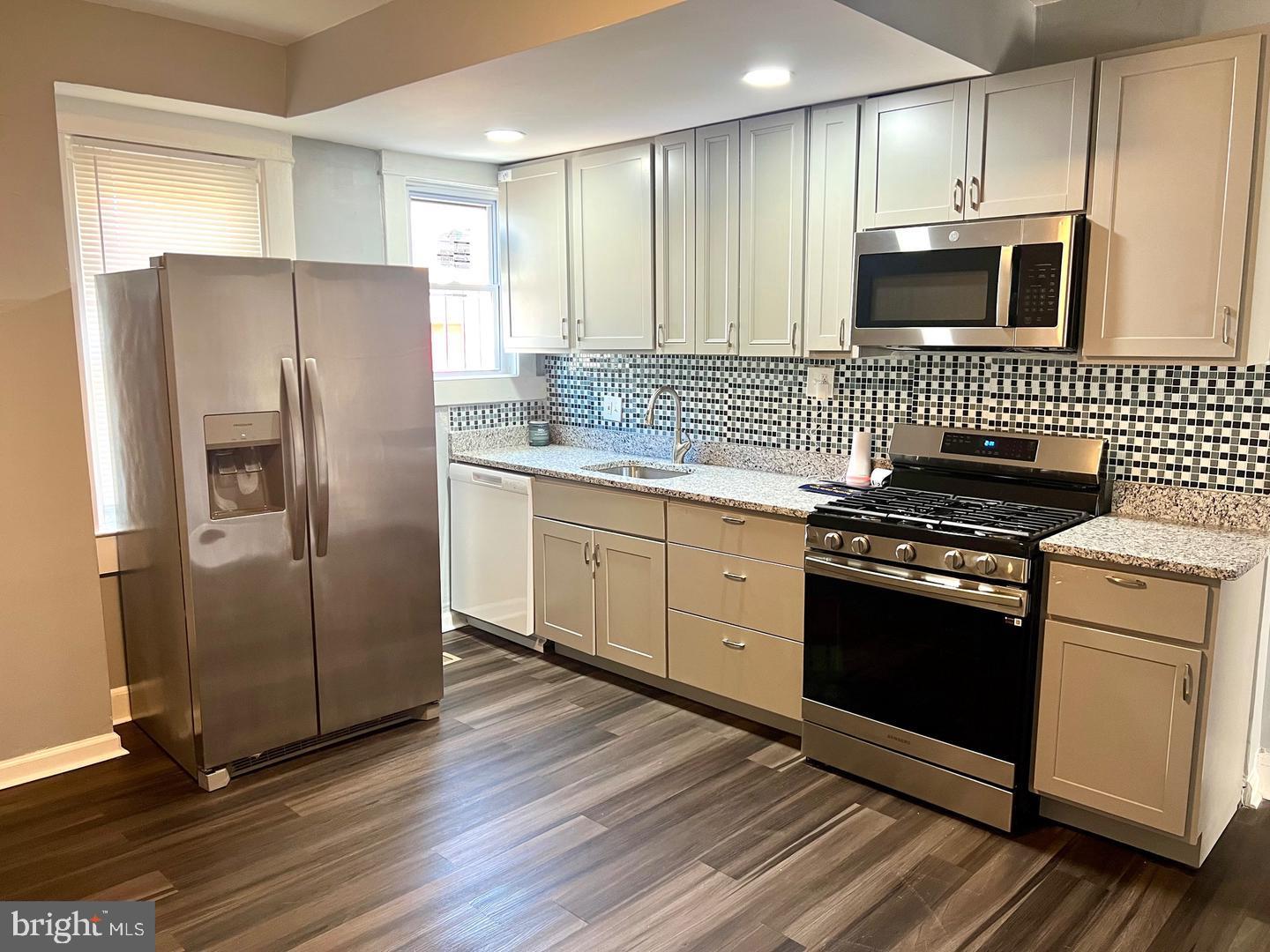 Why rent when you can own? This beautifully renovated end-of-group rowhome offers three finished levels of comfortable living space! Enjoy stylish wood-look laminate flooring throughout the upper levels, a bright and spacious living room, and an updated chef-inspired kitchen featuring granite countertops, stainless steel appliances, and a custom tile backsplash. The upper level offers two generously sized bedrooms and a full bath, while the finished lower level provides a third bedroom, an additional full bath, and a dedicated laundry area. Outside, you'll find a spacious rear yard perfect for entertaining, gardening, or relaxing. Conveniently located with easy access to major commuter routes, BWI Airport, and downtown Baltimore, this home is an excellent opportunity for first-time buyers or anyone seeking affordable homeownership.