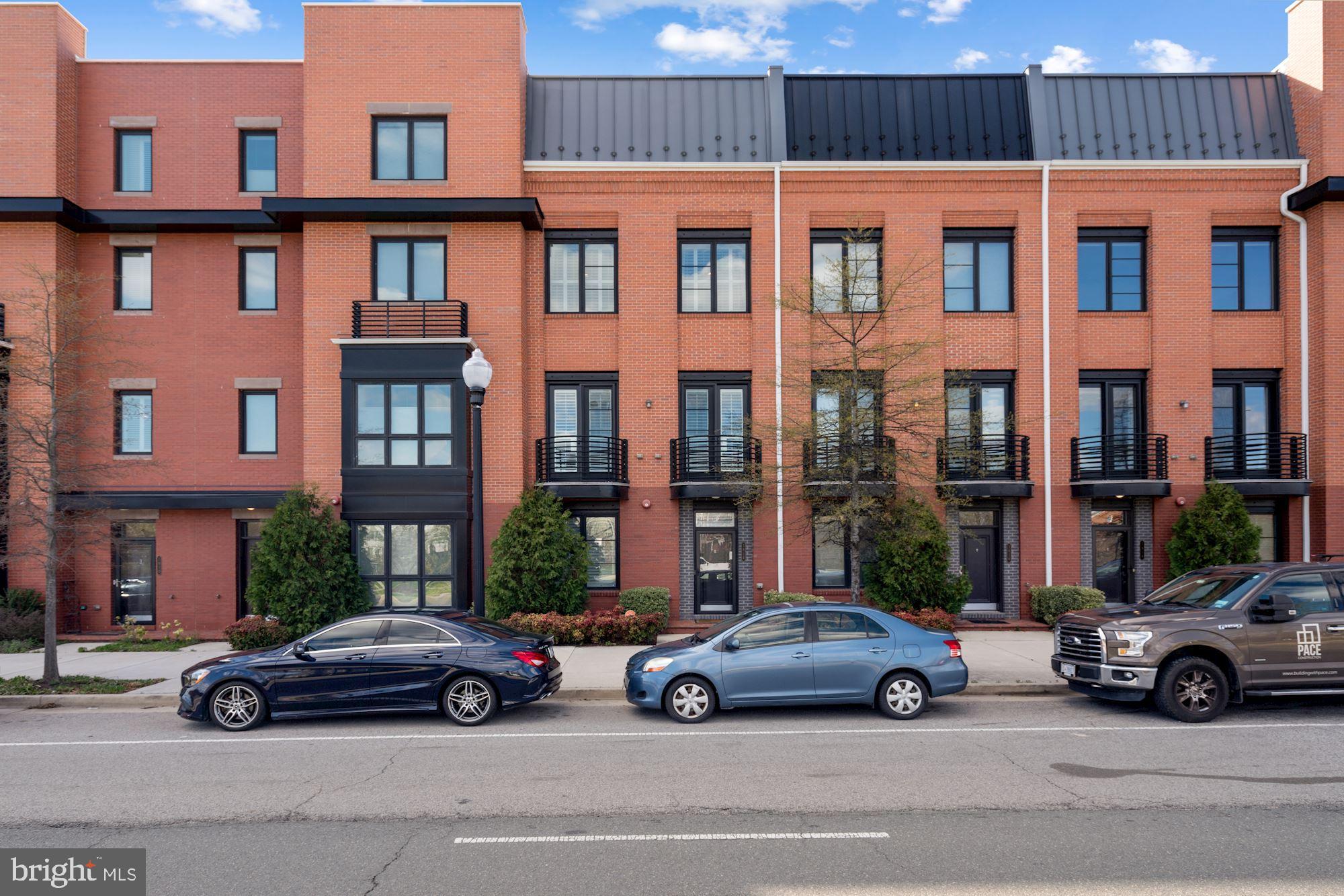 Beautiful 4 story townhome in sought after Potomac Yard! Completely move-in ready, with a private rooftop deck, 2 car garage,  and contemporary feel, this light filled living space features an entry room with entry level features a spacious bedroom and full bedroom. There are unique finishes  throughout the home including wood-plank hardwood flooring and a custom, wire-oak staircase. The main level features a completely updated open kitchen with stunning cabinetry, quartz countertops, and stainless steel appliances. The large dining area seamlessly moves into the living area with 2 private balconies. The upper level encompases the primary bedroom with a custom walk-in closet and spacious, upgraded ensuite bath. Another bedroom finishes this level with a second ensuite bathroom. All bathrooms are upgraded with granite counter tops and ceramic tiling. The fourth floor has ample space for a recreation or office area - complete with a custom set bar and wine fridge. This leads to a gorgeous rooftop deck with an indoor/outdoor fireplace. Just minutes from the Pentagon, tons of shopping & restaurants, and the new Amazon HQ - this home is going to go FAST!