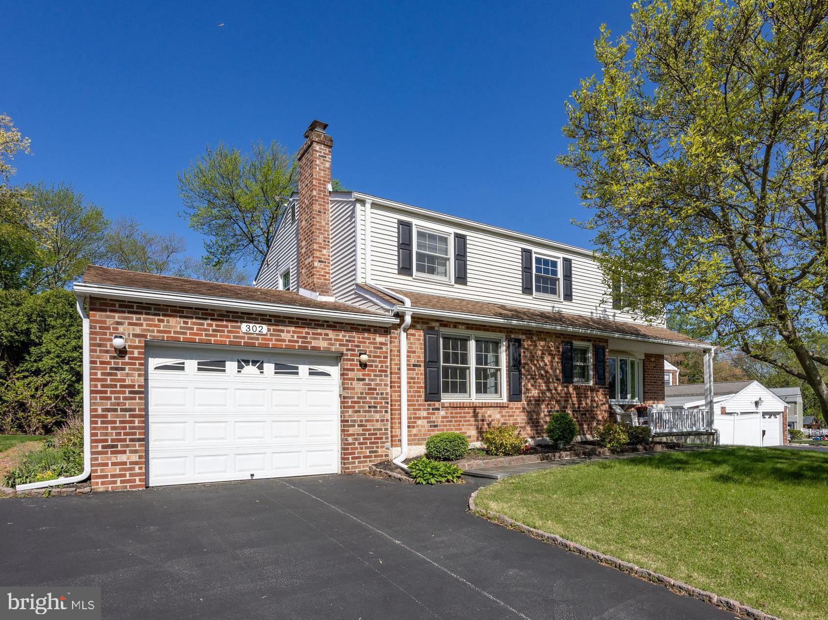 Welcome to 302 Rees Drive, a beautifully maintained home nestled in the highly desirable Sweetbriar community. Tucked away on a quiet street yet just moments from all the conveniences of King of Prussia, this charming home offers the perfect blend of serenity and accessibility. The charming front porch is a lovely place to sit and enjoy a cup of coffee! Step inside and be greeted by gleaming hardwood floors that flow seamlessly into an expansive living room, where a large bay window invites an abundance of natural light. The adjacent dining room provides an elegant space for hosting gatherings or enjoying intimate meals after a long day. At the heart of the home is the eat-in kitchen, thoughtfully designed with Corian countertops, a generous tile backsplash, an abundance of rich cherry cabinetry, and a spacious pantry. The breakfast area includes custom built-in cabinetry that offers additional storage, making this kitchen as functional as it is stylish. Just off the kitchen, the cozy family room with a gas fireplace sets the scene for warm, memorable evenings. For those who love indoor-outdoor living, the expansive three-season room is a true highlight, featuring skylights, ample space for lounging or entertaining, and easy access to the flat, private backyard. A powder room and access to the one-car garage complete the main floor.  Let’s head upstairs and check out the second floor! There you'll find a spacious primary suite with a newly renovated en-suite bathroom and a large walk-in closet. Three additional well-sized bedrooms and a full hall bath provide comfortable accommodations for family and guests. The finished basement provides additional living space, perfect for a game room, fitness area, or media lounge. Additional features include replaced windows throughout the home, handy pocket doors on the main floor, built-in hampers in both full bathrooms, and a large storage shed in the backyard for your outdoor tools and equipment. Located within the award-winning Upper Merion School District and just minutes from Heuser Park, the Schuylkill River Trail, Valley Forge National Park, and the vibrant King of Prussia Town Center, this home offers an exceptional lifestyle and location. Don’t miss the opportunity to make 302 Rees Drive your forever home!