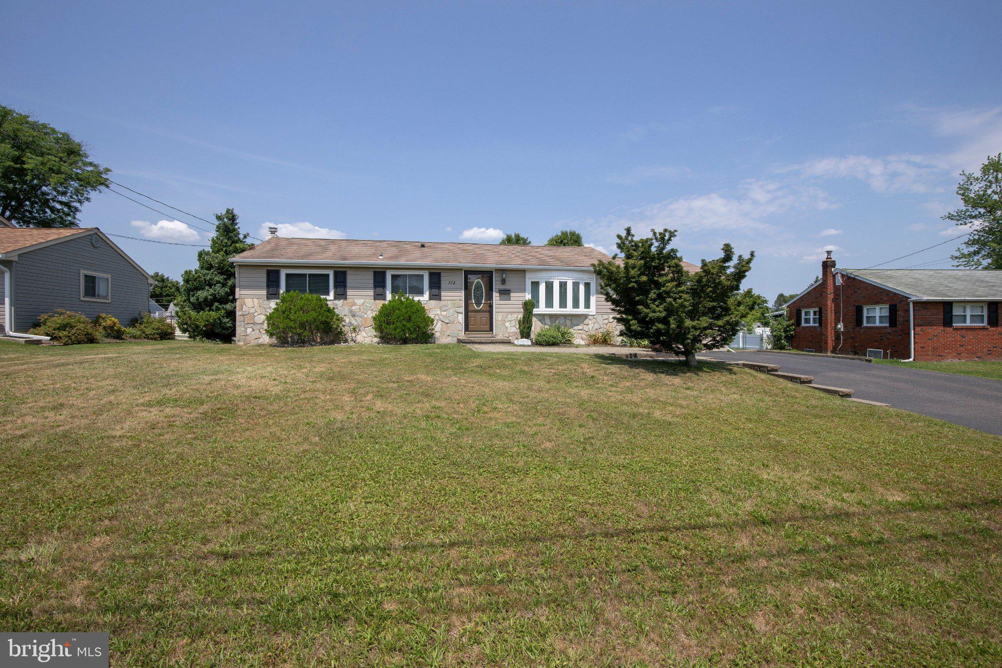 Rarely does a ranch home offer the flexibility found here. Beautifully maintained with timeless stone-front curb appeal, this inviting residence features a private guest/in-law suite with its own separate entrance, full bath, and prep area, ideal for multigenerational living, extended guests, a private home office, or flexible living needs.

A charming paver walkway and front patio welcome you inside to thoughtfully updated living spaces. The spacious eat-in kitchen features cherry cabinetry, Corian countertops, ceramic tile flooring, recessed lighting, and a classic tile backsplash. Just beyond, the sun-filled four-season room is surrounded by windows overlooking the fully fenced backyard. Complete with a cozy wood-burning stove and ceiling fan, this inviting space opens to a maintenance-free Trex deck and paver patio, creating the perfect setting for relaxing or entertaining.

Beautiful hardwood floors extend throughout all three bedrooms, each with generous closet space. A full hall bath serves the main level, while the professionally finished basement expands the home's living space with recessed lighting, a second full bath, and a separate laundry room, offering endless possibilities for a family room, recreation area, fitness space, or media room.

Additional highlights include replacement windows, 200-amp electrical service, pull-down attic storage, and two storage sheds with electric.

Ideally located within walking distance of Kemper Park and Little Neshaminy Creek Park, and just minutes from Five Ponds Golf Club, Warminster Community Park, shopping, dining, and everyday conveniences. Commuters will appreciate easy access to Street Road, Route 611, the PA Turnpike, and the SEPTA Warminster Regional Rail Line.

Offering the ease of one-floor living, exceptional versatility, and a prime location, this move-in-ready home is a rare opportunity.