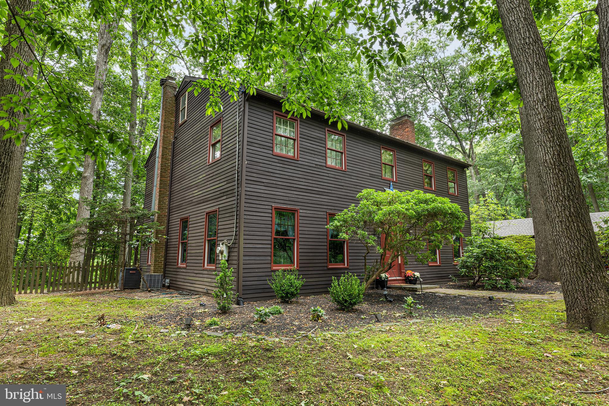 Welcome to this exceptional custom-built Center Hall Colonial, privately nestled on a private drive in desirable Bucks County. This beautifully appointed home offers timeless elegance, quality craftsmanship, and an impressive list of upgrades throughout. The main level features a spacious living room, a cozy den or home office with a corner fireplace, a warm and inviting family room with a stunning stone fireplace, and a formal dining room ideal for entertaining. The gourmet eat-in kitchen boasts upgraded cabinetry, granite countertops, a center island, a breakfast area with a 3rd fireplace, and French doors leading to expansive multi-tier decking overlooking the private wooded setting. Upstairs, the spacious primary suite offers generous closet space and a beautifully remodeled ensuite bath, complete with a walk-in shower and a jetted soaking tub. Three additional generously sized bedrooms and a full hall bath complete the second floor. Distinctive features throughout include heated tile flooring, random-width hardwood flooring, stone fireplaces, crown and chair rail moldings, and beautifully finished full tile bathrooms. Outside, enjoy the peaceful privacy of the wooded lot from the expansive multi-level deck, perfect for relaxing or entertaining. An oversized three-car garage provides abundant space for vehicles, storage, and hobbies. Conveniently located near major commuting routes, shopping, and everyday amenities, this outstanding Bucks County property offers the perfect combination of privacy, luxury, and accessibility.