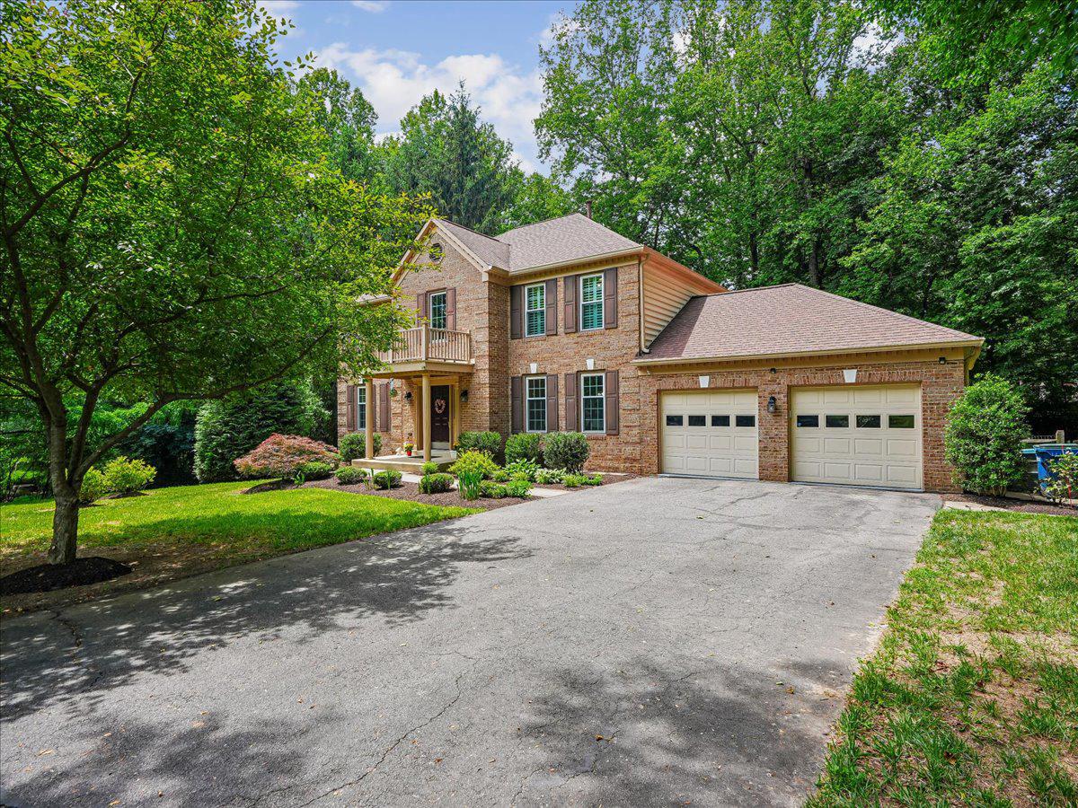 This is it...Welcome to this exceptional all-brick Colonial, ideally situated at the end of a quiet cul-de-sac on a beautifully landscaped and private 0.57-acre wooded lot.   With more than 4,100 square feet of finished living space, this elegant home seamlessly blends timeless architecture with modern updates and resort-style indoor-outdoor living.   A grand two-story foyer with a dramatic curved staircase sets the tone for the home’s classic center-hall Colonial design.   To the right, the formal dining room provides an elegant setting for entertaining, while to the left a spacious main-level office with double glass-paneled doors offers both privacy and sophistication for working from home.   Hardwood floors throughout the main and upper levels create a bright, airy atmosphere.  The updated kitchen features an eat-in breakfast area, butler pantry, and effortless flow into the expansive family room with a cozy gas fireplace.   Sliding glass doors lead to a large Trex deck overlooking the serene, tree-lined backyard—perfect for outdoor dining, entertaining, or quiet relaxation.   Upstairs, the luxurious primary suite offers two oversized closets and a beautifully remodeled, spa-inspired bath.   Three additional generously sized bedrooms and a full hall bath complete the upper level.   The fully finished walk-out lower level provides exceptional versatility with luxury vinyl flooring, a spacious recreation area ideal for a gym, game room, or media space, a bonus room perfect for guests or hobbies, a full bath, a custom wet bar with refrigerator, and a charming wood-burning fireplace.   Step outside to the screened-in porch and unwind in the six-person hot tub surrounded by mature trees and total privacy.   This extraordinary property delivers the perfect balance of classic Colonial charm, thoughtful modern upgrades, and peaceful outdoor living—all in a prime location with convenient access to Interstate 66, Interstate 95, Interstate 495, Fairfax County Parkway, and the Burke Centre VRE Station.  Simply a beautiful and relaxing place to come home to!