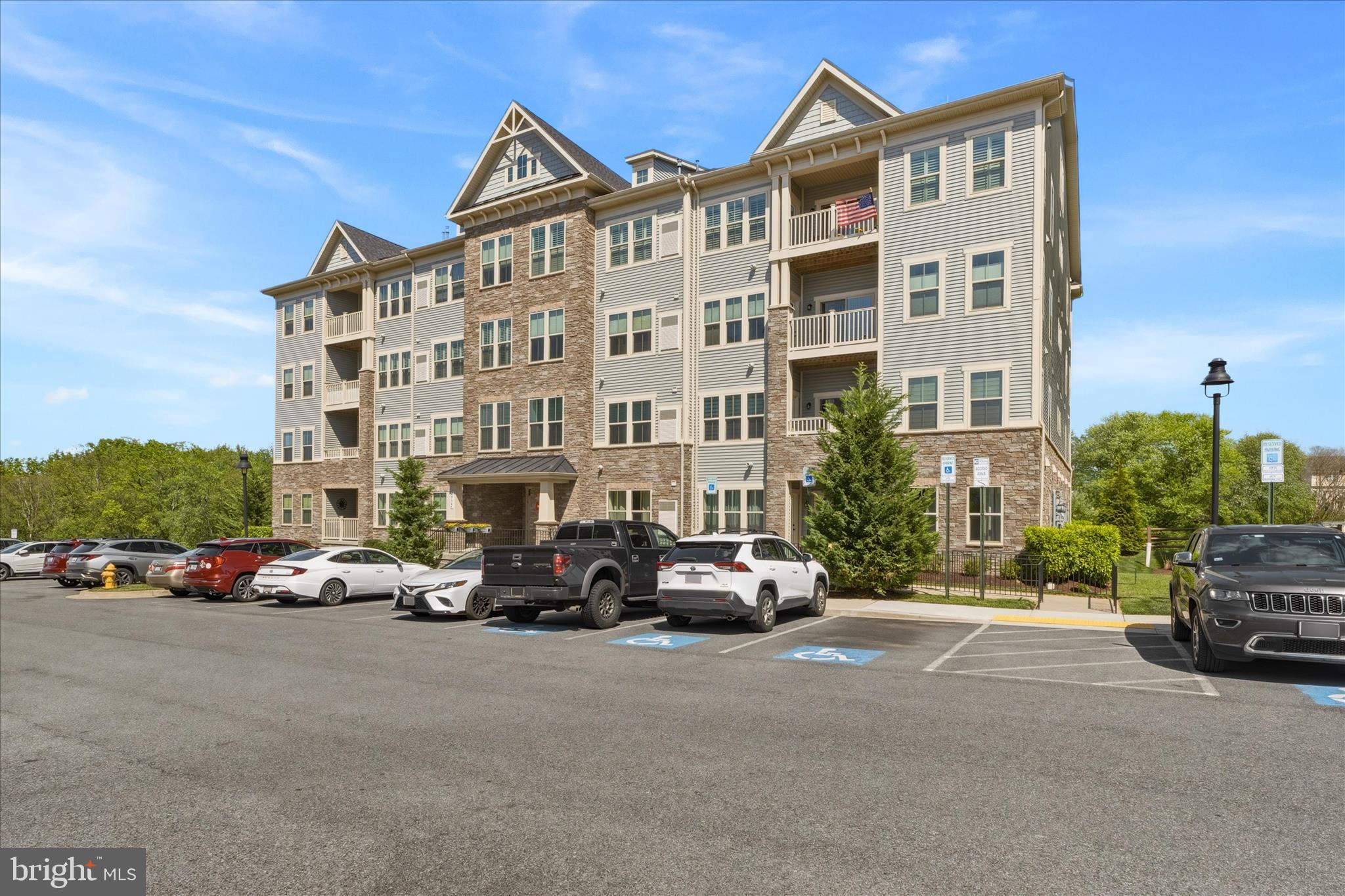 This is NOT the average condo building! Turn Key, Meticulously cared for condo in a desirable elevator building in Lake Linganore! This bright and spacious open-concept home features durable LVP flooring throughout the main living areas and a sliding glass door leading to a private deck overlooking peaceful wooded views. The gourmet kitchen offers granite countertops, abundant cabinet space, and ample storage. The spacious primary suite includes two deep closets and en-suite with dual sinks, and a large walk-in shower. The second bedroom also features deep closets and its own private bathroom.  Parking here is easy, lots of parking spaces out front as there open space of one side of the building. Easy walk to the schools and shopping across the street. Easy commuter access to I-70. HOA fees includes all that Lake Linganore has to offer!