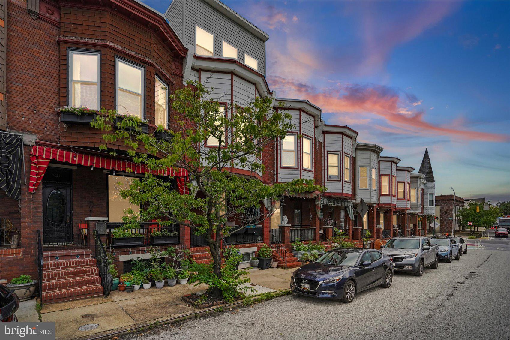 Step into timeless elegance in this stunning classic Victorian Baltimore brick townhome, where historic character blends seamlessly with modern style. Inside, you'll be greeted by soaring ceilings, abundant natural light, rich hardwood floors, elegant crown molding, and a striking statement column that enhances the home's architectural appeal.

The inviting living room centers around a beautiful original wood-detailed fireplace, with a marble hearth, now featuring a stylish electric insert, creating the perfect focal point for relaxing or entertaining. The original wooden staircase serves as another beautiful reminder of the home's craftsmanship and history.

French doors lead to a spectacular formal dining room complete with crown molding, contemporary lighting, and custom built-in bookcases that add both character and functionality. The galley kitchen is thoughtfully designed with stainless steel appliances, intricate tilework and recessed lighting.

The finished lower level offers exceptional flexibility with a private bedroom, full bathroom, and dedicated laundry area, making it perfect for guests, a home office, or additional living space.

Upstairs, you'll find two spacious bedrooms filled with natural light, updated ceiling fans, and a beautifully renovated full bathroom featuring elegant marble tile. Hardwood flooring and updated carpeting provide comfort and style throughout the upper level.

Every detail of this truly gorgeous Victorian has been carefully maintained to preserve its historic beauty while offering today's conveniences. This is a rare opportunity to own a home that perfectly captures the charm, craftsmanship, and timeless appeal that make Baltimore's classic townhomes so beloved.