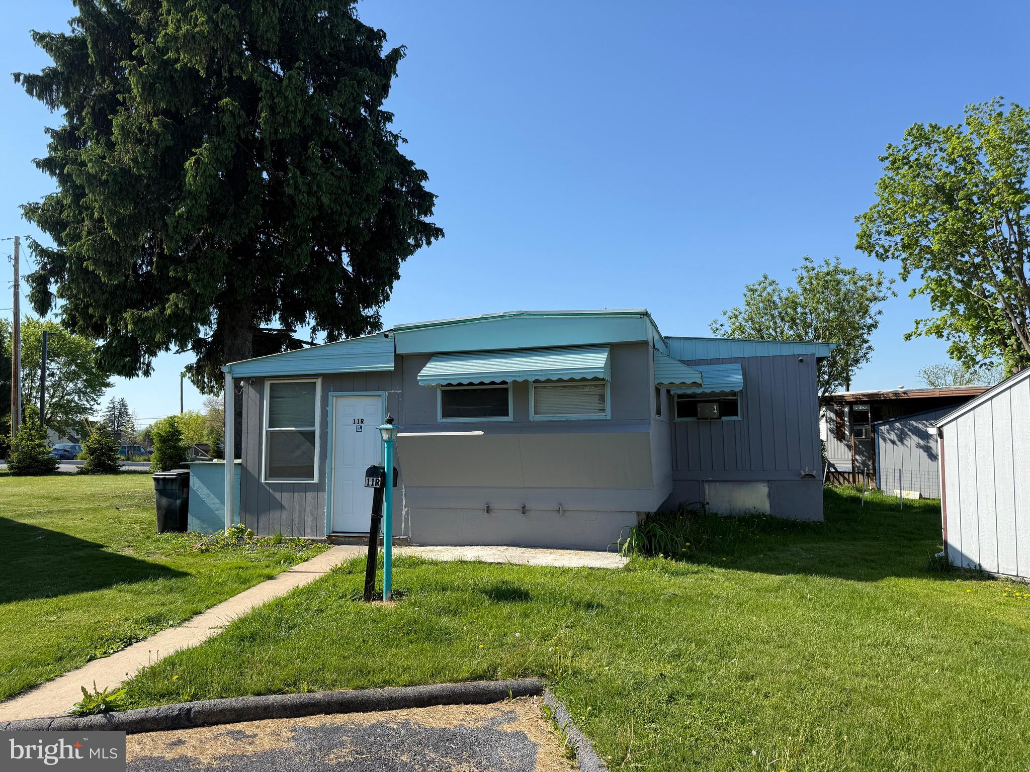 Discover value and surprising space in this uniquely expanded mobile home. Originally a 2-bedroom, 1-bath layout, this residence has been enhanced with additions on both sides, bringing the total estimated living area to over 1,000 square feet. To the left, you'll find a versatile enclosed porch, a shed for extra storage, and a flexible third room perfect for an office or guest space. The right-side addition expands the dining area, creating a more open environment for meals and gathering. The monthly ground rent is $350 and includes sewer service. Sold as-is, this home is a fantastic canvas for cosmetic updates and is priced to sell quickly. Best of all, this community is now open to all ages and is pet-friendly! Schedule your showing today and imagine the possibilities.
