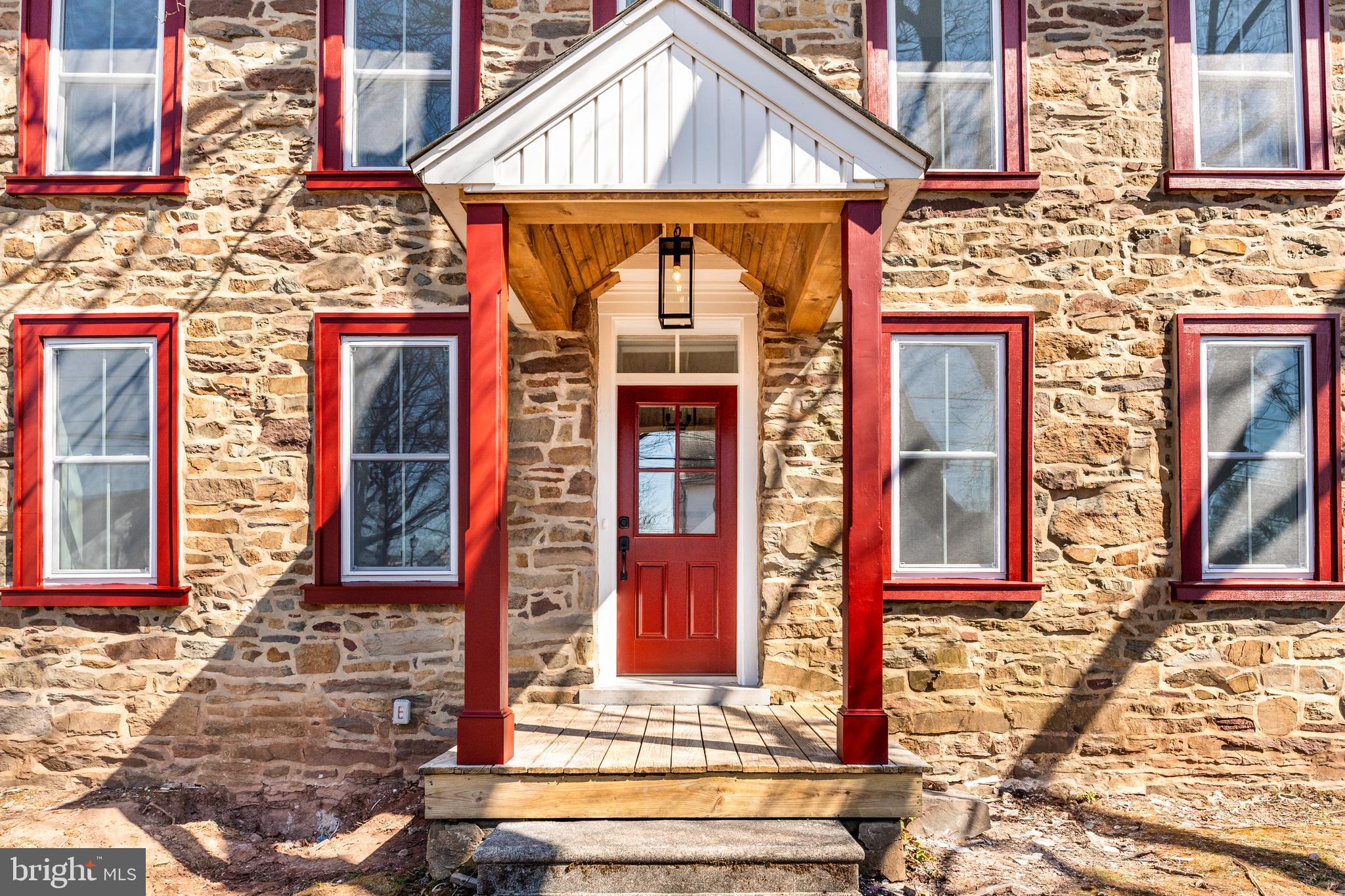 Thoughtfully designed, this four-bedroom, two-and-a-half-bath stone farmhouse offers an inviting open-concept floor plan that is perfect for everyday living and effortless entertaining. The first floor welcomes you with a charming mudroom featuring built-in cubbies, providing the perfect place to keep coats, shoes, and everyday essentials neatly organized. A versatile room with elegant French doors offers endless possibilities as a home office, playroom, den, or optional first-floor bedroom. A convenient powder room completes the main level. At the heart of the home, the spacious kitchen features stainless steel appliances, abundant counter space, and an inviting layout designed for gathering with family and friends. The kitchen flows seamlessly into the living and dining areas, creating a bright, open atmosphere ideal for both casual living and entertaining. Rich hardwood flooring extends throughout the first and second floors, adding warmth and timeless character, while deep windowsills throughout the home enhance its classic farmhouse appeal. Upstairs, the second floor features a convenient laundry room, a beautifully appointed hall bath, and a peaceful primary suite complete with a private en-suite bath. Two additional bedrooms offer generous closet space and flexibility for family, guests, or hobbies. The third floor showcases a charming loft-style bedroom that serves as the perfect private retreat, guest suite, or creative space. Outside, enjoy the charm of village living with local favorites just moments away. Located just a stone's throw from Skippack Village, you'll love exploring its quaint boutiques, exceptional dining, and year-round community events. Nearby Lederach offers additional conveniences, including Bay Pony Inn, Mojo Yoga, and Wawa. Golf enthusiasts will appreciate nearby Lederach Golf Club, while outdoor lovers can enjoy the area's parks, walking trails, and green spaces. With convenient access to major commuter routes, this exceptional home offers the perfect blend of small-town charm, modern comfort, and everyday convenience.