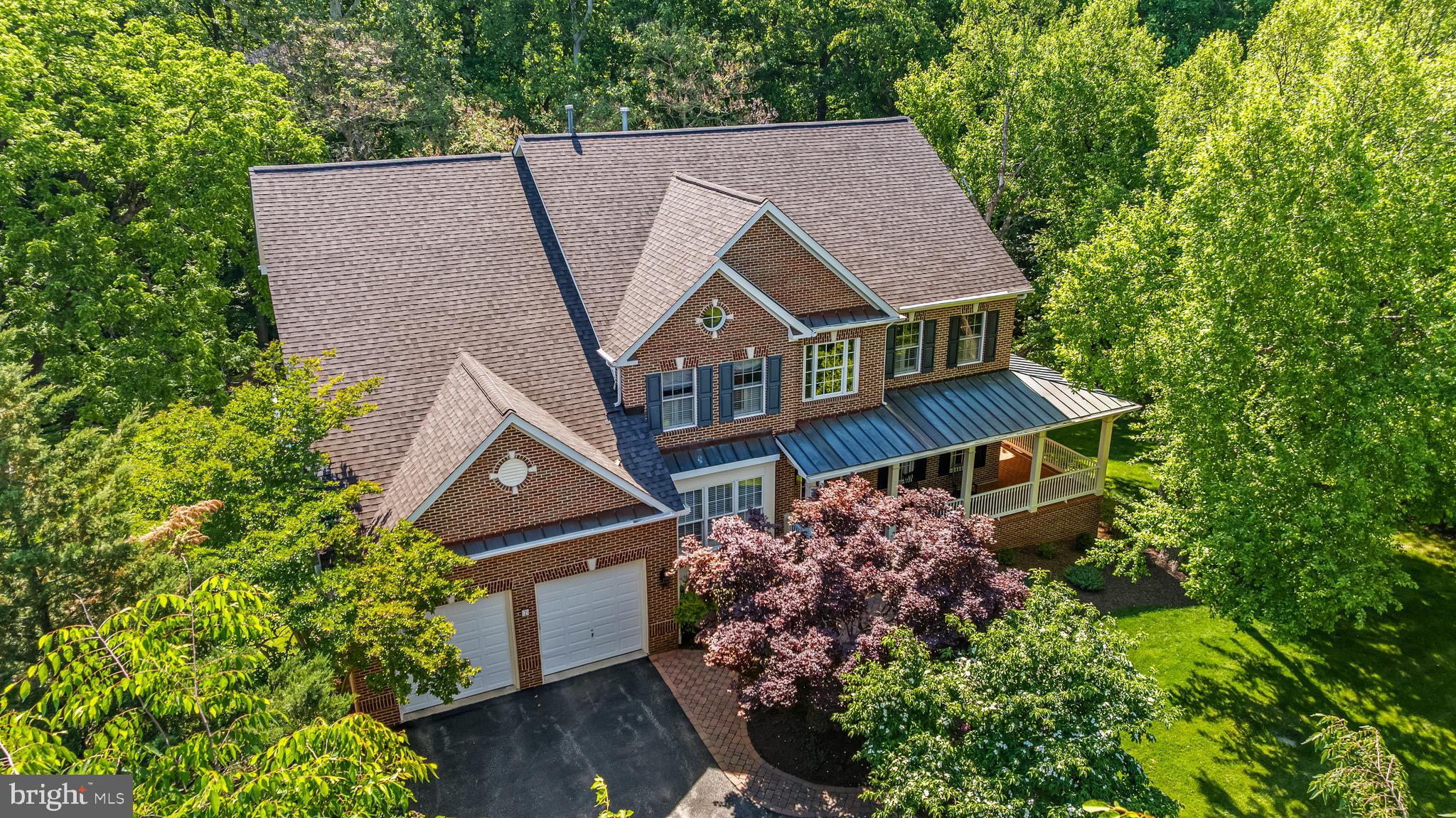 Traditional Colonial with 5 bedrooms, 4.5 baths nestled on a quiet cul-de-sac in sought after "Jenifer Ridge." The main level is thoughtfully designed for both everyday living and entertaining, featuring formal living and dining rooms, an open-concept kitchen with adjoining breakfast nook & sitting area, a sunken family room with fireplace, and a private office just off the dramatic two-story foyer. The upstairs offers four spacious bedrooms and three full baths, including an expansive primary suite with a sitting room, dual walk-in closets and luxury bath.  The finished walkout lower level expands the living space with a large recreation room, kitchenette, bedroom, and full bath — ideal for guests, in-laws, or extended stays. Outdoor living is equally inviting with a deck off the kitchen overlooking the very private backyard and patio below. Additional highlights include a welcoming covered front porch, two-car garage, and beautifully tucked-away setting offering both privacy and neighborhood charm.