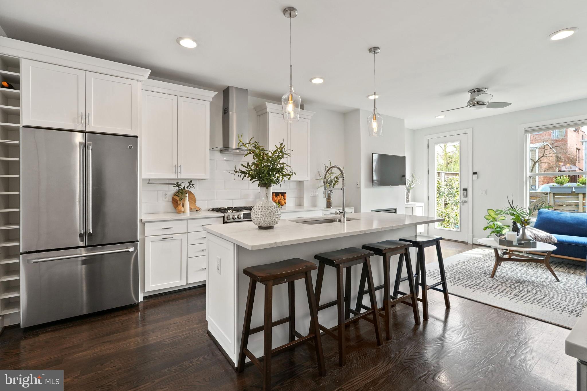Smart, sexy, and environmentally friendly. It is an urban retreat with a small-town feel and is worthy of a luxe magazine spread. Instantly fall in love with the lifestyle 212 S. Patrick Street delivers. Start your day with a fresh cup of joe from Old Town’s iconic coffee shop, Misha's, on your short walk to work, Metro, or drop-offs to nearby schools. Leave your car in the two off-street parking spaces and stroll down King Street, perusing the shops on your way to happy hour or dinner at one of the city's many award-winning restaurants. If you prefer, you can also enjoy just staying home on your private patio or roof deck. Four finished levels, gleaming hardwood floors, oversized sound-reducing windows, and beautiful moldings throughout. An open-concept main living layout is a versatile space to make your own with 10-foot ceilings, a combination living/dining area, a sophisticated kitchen with designer finishes and all the bells and whistles, and an adjacent family room so you never miss a beat! Entire second-floor primary suite with walk-in closet (almost 12x8) and luxury spa-inspired bathroom with walk-in shower and double vanities. Top floor with two bedrooms, a full bath, and access to the rooftop deck offers excellent city views. A finished basement with 9-foot ceilings, a large rec room, a bedroom, and a full bath is perfect for guests and family to relax. This home has it all!