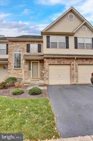Welcome to this beautifully updated and spacious townhome in the highly sought-after Waterford Greene community, offering the perfect blend of style, comfort, and low-maintenance living. The open-concept main level features luxury vinyl plank flooring, a spacious living and dining area highlighted by a charming board and batten accent wall, and a cozy family room with a gas fireplace. The updated kitchen boasts white cabinetry, granite countertops with a peninsula, subway tile backsplash, stainless steel appliances, and updated hardware, while a convenient powder room completes the first floor. Step outside to the recently refreshed deck with new decking boards and a retractable privacy screen overlooking open green space. Upstairs, the spacious primary suite features a vaulted ceiling, a custom walk-in closet, and a beautifully updated ensuite bath with a double vanity, jetted tub, and separate shower. Two additional bedrooms, one with a removable wallpaper accent wall, a refreshed hall bath, and a second-floor laundry room add to the home's functionality. The finished lower level provides an expansive recreation room ideal for entertaining, a home gym, or media space, along with unfinished storage. Additional highlights include new front landscaping, a new central air conditioning system installed in 2023, an attached one-car garage, driveway parking, and additional guest parking nearby. The HOA offers exceptional value by covering building roof replacement (individual roof repairs are the homeowner's responsibility), annual mulching, lawn mowing and fertilization, annual leaf cleanup, and scheduled tree and shrub trimming, making this move-in-ready home an outstanding opportunity in one of the area's most desirable neighborhoods.