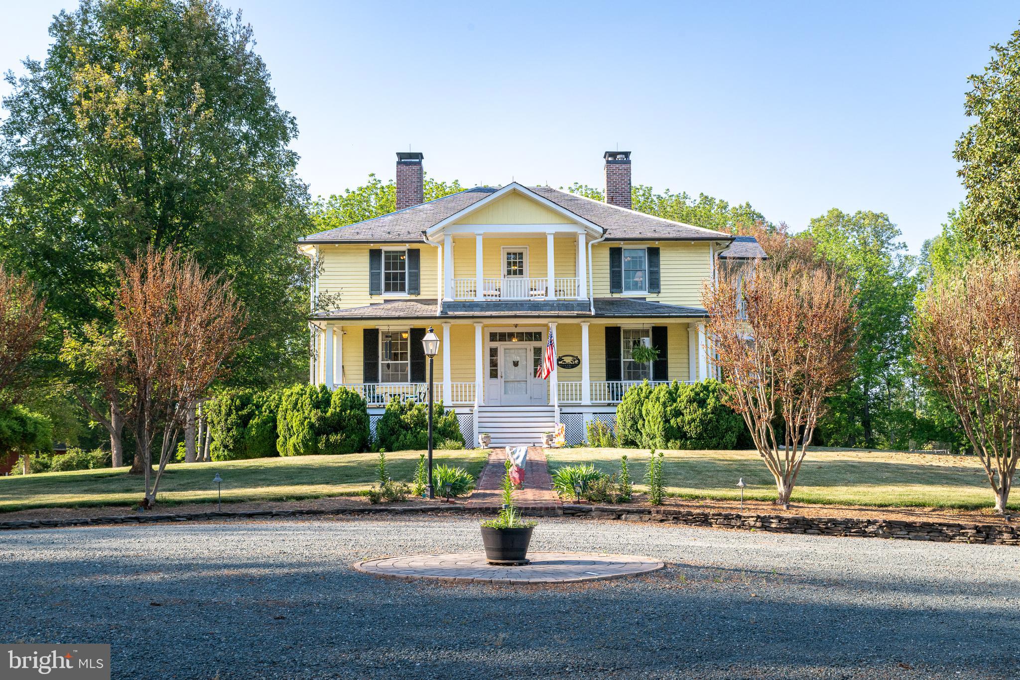 Solitude — Circa 1860. An exceptional Virginia estate sited on a private knoll overlooking 46+ acres of meticulously tended land. This stately four-over-four residence welcomes you with an elegant open entry hall, soaring 11-foot ceilings, and richly detailed, timeless architectural craftsmanship.

Graceful indoor/outdoor living is featured throughout: expansive main‑floor porches and upper balconies frame views of mature specimen trees and new plantings, creating an ideal country retreat or a striking venue for gatherings and events. The main living, dining and library/office flow in a gracious circular plan—excellent for entertaining—while the main‑floor primary suite opens directly to secluded outdoor living spaces.

A thoughtfully appointed gourmet kitchen and sunny breakfast room occupy the rear of the home, fully outfitted for everyday comfort and large-scale hospitality. The lower level reveals a rare brick‑walled tavern room dating to the mid‑1700s, connected to a cozy private theater—a remarkable blend of history and modern amenity. The house has been exquisitely maintained, sensitively remodeled and updated to offer all of today’s conveniences without compromising period character.

The property includes a handsome  barn, currently used for workshop and storage, and plenty of room for expansion. Ideally located just 5 minutes from the charming town of Palmyra and approximately 15 miles from Charlottesville via the scenic Thomas Jefferson Parkway.

A rare offering for the buyer seeking historic integrity, privacy, and turnkey country elegance. Contact for private showing and additional property details.
