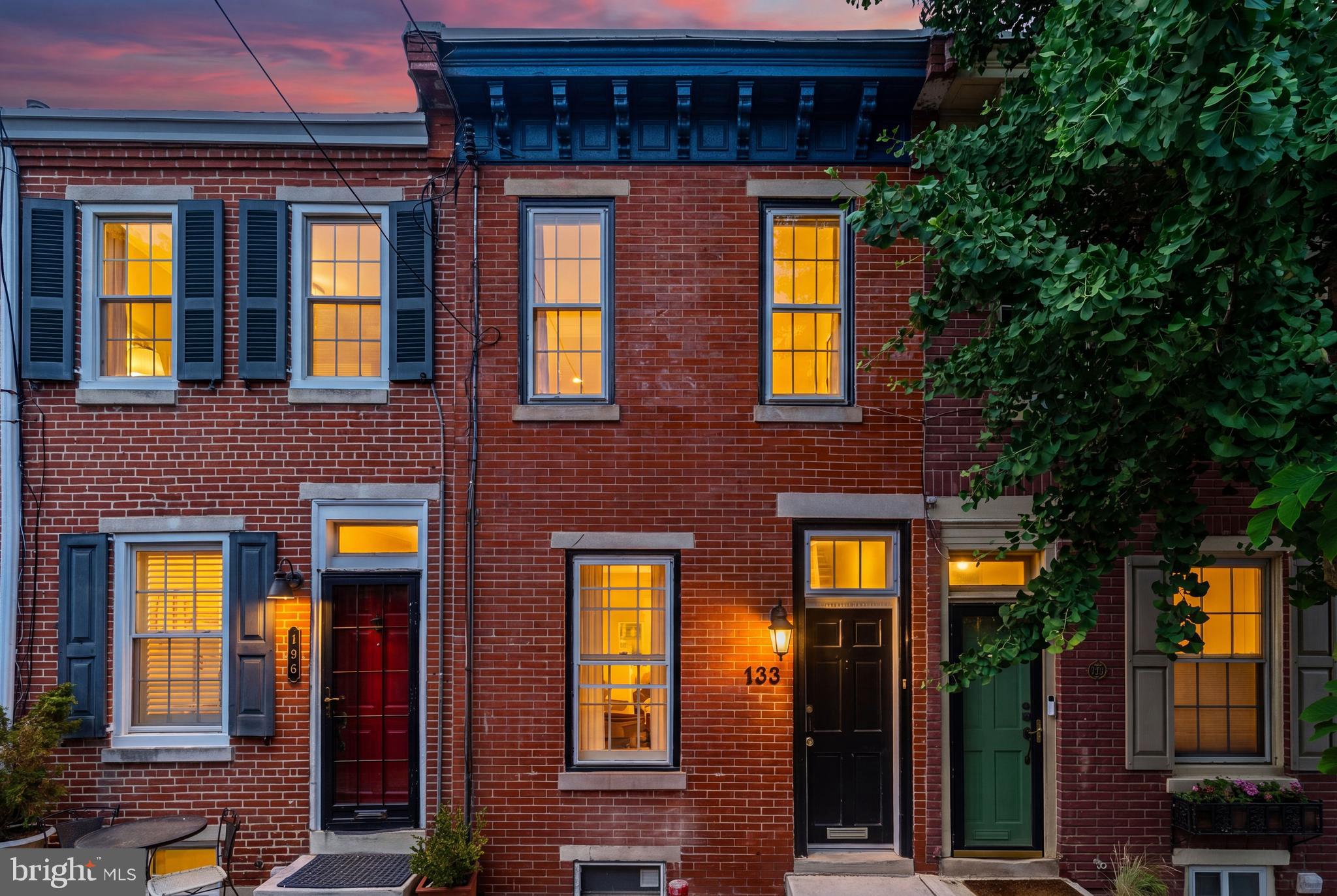 Located on a quiet, historic street in Queen Village, 133 Monroe has undergone a thorough renovation while preserving its original charm.
Step inside the foyer and immediately take in the spacious area lined with a stunning exposed brick wall that extends from the living room up through the second level, adding warmth and character to the space. The living area is bathed in natural  southern light from oversized windows, creating an inviting and airy atmosphere, and features a custom stair railing with handcrafted stained wood detail. 

The dining area flows seamlessly into the kitchen, making it perfect for both everyday living and entertaining. The kitchen features granite countertops, new stainless steel appliances, freshly painted high-gloss white cabinets, a new 8-inch sink with a high-spray faucet, new durable LifeProof waterproof tile flooring with a 20-year warranty. A back door leads directly to your private enclosed backyard, freshly painted with new concrete flooring—perfect for outdoor dining and relaxing.

Upstairs, the primary bedroom is incredibly spacious and filled with natural light from two large front-facing windows. The second bedroom is very bright and features large closets with systems for ample storage. Both bedrooms share a fully gut-renovated bathroom with brand-new grey 18-inch tile floors, a retiled tub with a third accent wall for a modern spa feel, a new dual-flush water-saving toilet, new vanity with medicine cabinet, glass vanity lighting, chrome Delta faucets, a built-in pull-out storage shelf, and a skylight.

The basement provides a built-in washer and dryer along with even more storage space.

The entire property, including the backyard, window sills and doors inside and out,  along with each wall within the home, have been freshly painted. Every outlet and light fixture was replaced by a licensed electrician. The floors in the kitchen and bathroom have been replaced, while leaving the original hardwood floors in the rest of the home.  

Located just minutes from Center City Philadelphia, the Delaware River Waterfront, major highways, and public transportation, this home offers unmatched convenience. Enjoy being close by some of the city's best dining, shopping, and neighborhood charm.

Opportunities like this in Queen Village don't come around often, schedule your private showing today!