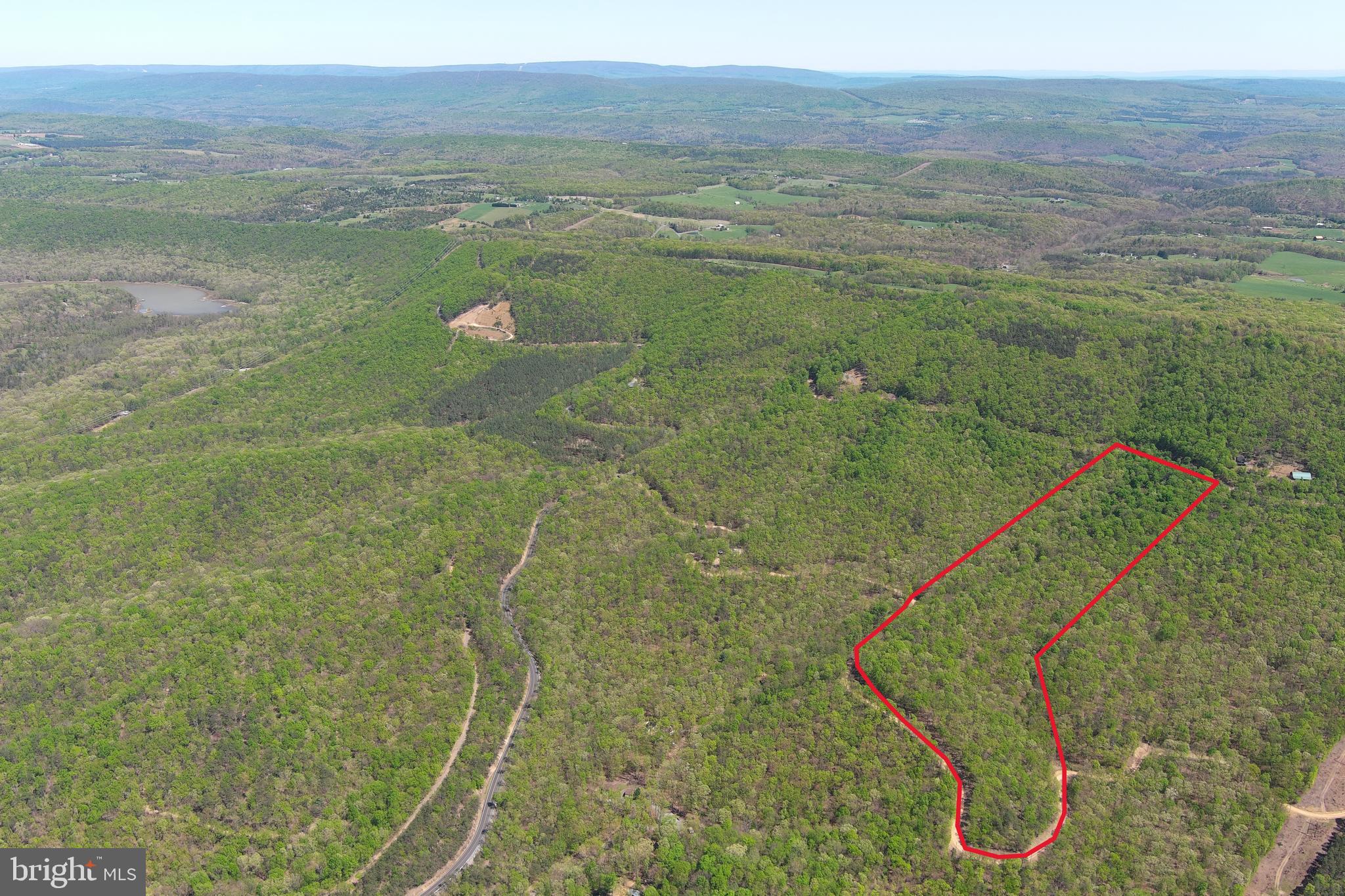 USE IT ALL....20 ACRES OF 100% USABLE PRISTINE HARDWOOD FOREST. HUGE FLAT RIDGE OFFERS MULTIPLE BUILD SITES WITH VIEWS TO NORTH & WEST....PLENTY OF SPACE FOR YOUR HOME & ACCESSORY BUILDINGS. POWER & PERKED, ELECTRIC VERY CLOSE TO BUILD/CAMP SITE. OLD LOGGING ROAD RUNS THROUGH THE ENTIRE PROPERTY AND WILL BE UTILIZED AS YOUR DRIVEWAY.....MINIMAL INFRASTRUCTURE COSTS TO GET THIS PROPERTY FULLY FUNCTIONAL. NEVER SEE A NEIGHBOR, VERY PRIVATE, YET VERY CONVENIENT.....LESS THAN A 1/2 MILE OFF THE PAVED ROAD AND WITHIN 10-15 MINUTES OF MULTIPLE SMALL TOWNS. IF YOU LIKE THE OUTDOORS, YOU'LL NEVER GET BORED.....3 PUBLIC ACCESS POINTS ON THE SOUTH BRANCH OF THE POTOMAC RIVER AND "WHITEHORSE MOUNTAIN WILDLIFE MANAGEMENT AREA" 1765 ACRES OF PUBLIC HUNTING WITHIN 5 MINUTES OF THIS PROPERTY......A RECREATION OASIS! HUNT, CAMP, SHOOT, ATV'S.....YOU CAN DO IT ALL ON THIS LAND! BIG GAME SIGN EVERYWHERE YOU LOOK....BUCK RUBS, TURKEY SCRATCHING & BEAR SCAT. LOCATED IN THE DEVELOPMENT OF "SHADOW KNOLLS" AN 800 ACRE COMMUNITY COMPRISED OF ONLY 28 TRACTS, MOSTLY WEEKENDERS WITH ONLY A FEW FULL TIMERS, VERY LOW KEY AND PRIVATE..... MINIMAL RESTRICTIONS & HOA DUES ONLY $225 PER YEAR. I HAVEN'T SEEN 20 ACRES THIS NICE FOR UNDER 100K SINCE COVID.....THE FIRST ONE HERE IS GONNA GET A DEAL....GRAB YOUR CAR KEYS & CHECKBOOK AND HEAD THIS WAY!