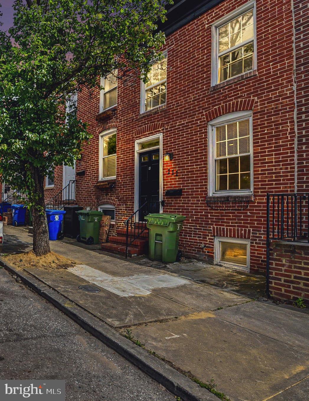 Welcome to this charming Federal-style rowhome in the heart of Federal Hill. Combining historic character with modern updates, this move-in-ready home offers approx 900 SQ ft of comfortable living space. The main level features fresh paint, abundant natural light, and a spacious living room highlighted by exposed brick accents. The updated kitchen provides direct access to a private rear patio, creating an ideal space for outdoor dining and entertaining. Upstairs, you'll find two generously sized bedrooms with new carpet, ample closet space, and a full bathroom. The partially finished basement adds valuable flex space and includes a convenient half bath. Located in one of Baltimore's most sought-after neighborhoods, this home is just moments from Riverside Park, local restaurants, shopping, and all the conveniences of city living.