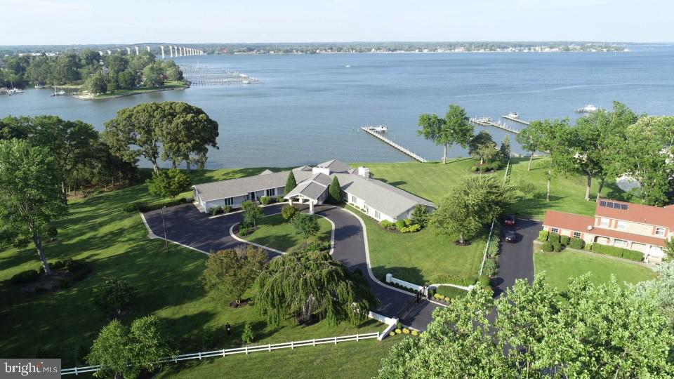 Breathtaking Waterfront Retreat with Panoramic Views of the Patuxent River

Enjoy front-row seats to air shows and stunning views of Solomons Island and Pax Naval Air Station from this beautifully renovated home, where no detail was overlooked.

The gourmet kitchen is a chef’s dream—featuring quartz countertops, custom two-tone cabinetry, Sub-Zero refrigerator, Wolf gas range, and stainless appliances. The great room impresses with a dramatic arched ceiling, exposed wood beams, a gas brick fireplace, and a wall of windows that frame the water views.

Designed for entertaining, the home includes a spacious gathering area with a wet bar and conversation space. All bedrooms offer generous layouts and en-suite baths, including a luxurious owner’s suite with his-and-her bathrooms. 

The finished basement boasts a third fireplace and ample additional living space. Outside, a gated driveway offers privacy, and an additional lot conveys with the property. The private pier includes a boat lift, gazebo, and access to a sandy beach.

Located just minutes from Solomons Island by boat or car, this rare offering combines luxury, location, and lifestyle.