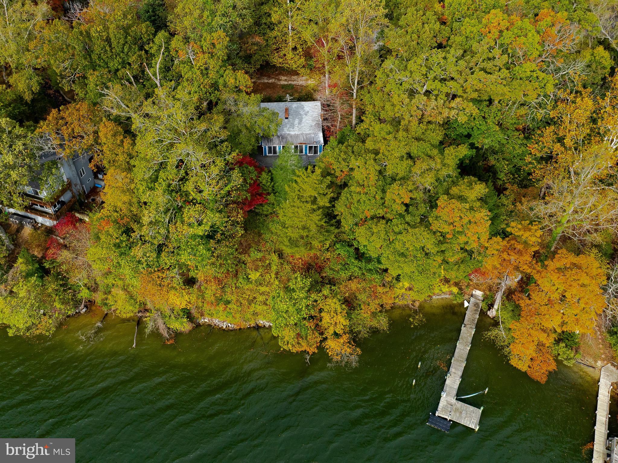 Enjoy waterfront living with this cottage style home offering breathtaking views of the Patuxent River and St. Thomas Creek. The open main-level floor plan of this 2BR 2FB home captures water views from most areas of the home, as does the rear of the fully finished walkout-level basement. The spacious walk-up attic could potentially offer future expansion into a third floor, perhaps maybe with dormers, to  further expand living space with even more stunning panoramic views.

Enjoy the outdoors from the large rear deck or take advantage of direct water access with a private pier, jet ski ramp, boat lift, pier-side storage shed, and small beach area at the water’s edge. The pier provides easy access to navigable waters, perfect for boating, fishing, and exploring the Patuxent River, the Solomons Island area and the many Chesapeake waterways. A detached screened patio with a wood burning stove invites outdoor dining or peaceful relaxation with picturesque water views.  

Set in a peaceful, private country setting, this property invites you to entertain or just simply relax and unwind while enjoying unforgettable sunrises and sunsets over the water,  all from the comfort of your own backyard.  Don't miss this rare opportunity to enjoy your own piece of waterfront paradise.  The horse shoe style driveway with parking area offers plenty of off street parking.

The home is being sold in as-is condition.  Septic testing found the current mid-seam septic tank and fields to be in unacceptable condition.   Seller is in contact with Health Department researching septic options and next steps.  The cost of the tank replacement could potentially be offset, or possibly covered, through the The Maryland Bay Restoration Fund.  Interested purchasers may want to contact the St. Mary’s County Health Department’s Clear Water Program, which administers the Bay Restoration Fund (BRF) in St. Mary’s County, for further information.