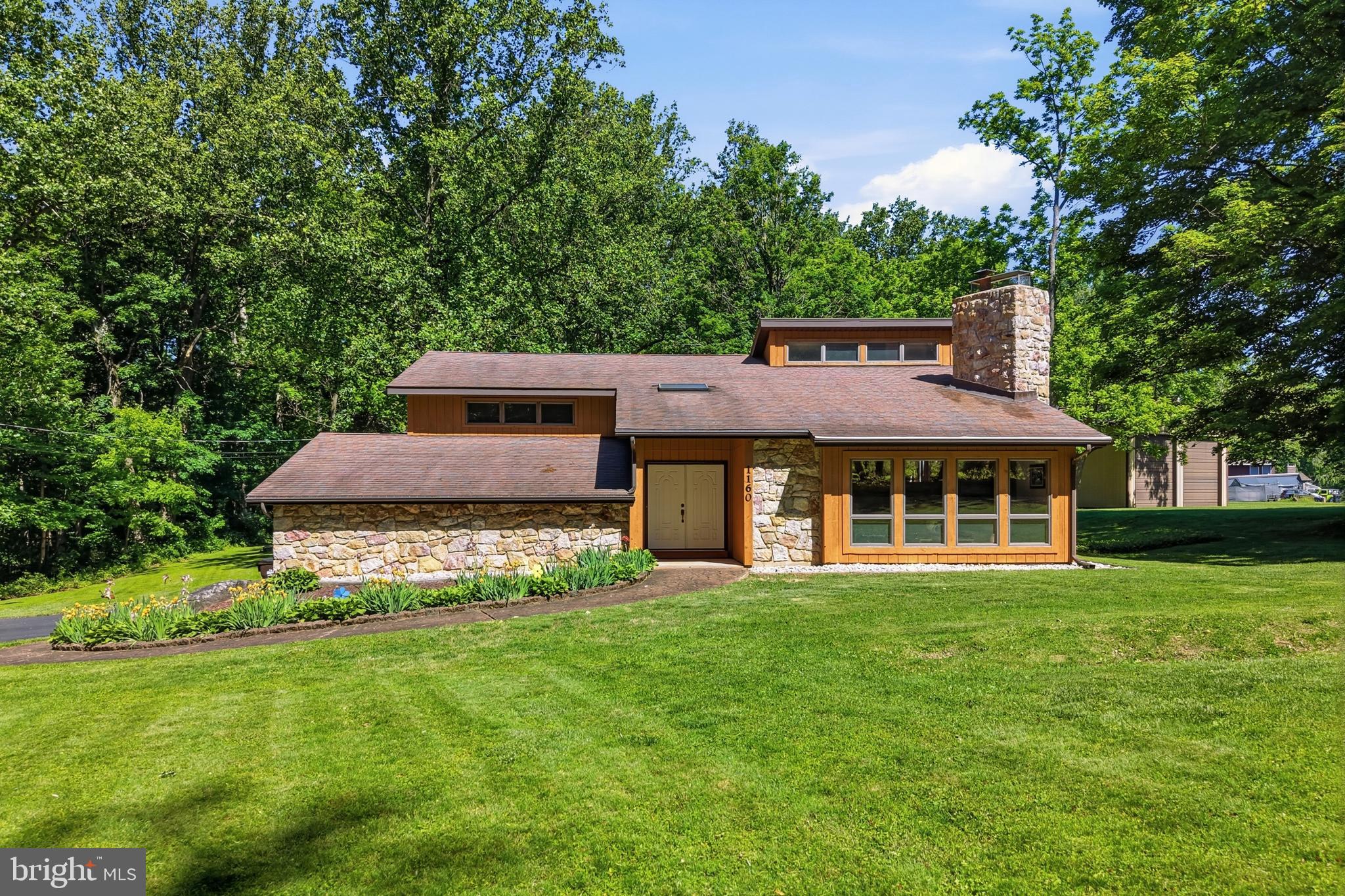 Custom Contemporary Home nestled on a beautiful 3+ acre lot with curb appeal and peaceful surroundings! Lovingly maintained by its original owners, this exceptional home offers spacious multi-level living designed for both comfort and entertaining. Step inside to find soaring vaulted ceilings, windows and skylight that fill the home with natural light, and a dramatic floor-to-ceiling stone fireplace that creates a warm and inviting centerpiece. The thoughtfully designed layout provides plenty of space to spread out having 3 bedrooms, 2 full baths, living room, dining room, and an eat in kitchen. Enjoy relaxing or entertaining on the rear deck or lower level patio overlooking the expansive property and scenic views. The walk-out lower level features a cozy coal-burning stove, additional family room, and a large workshop room perfect for woodworking, hobbies, storage, or potential conversion into an additional bedroom or flex space. In addition to the attached 2-car garage is the enormous 30’ x 56’ pole barn with 16-foot ceilings and multiple overhead doors—ideal for contractors, car enthusiasts, hobbyists, or anyone needing exceptional storage and workspace. Combining privacy, character, functionality, and meticulous care, this one-of-a-kind property is truly a must see!