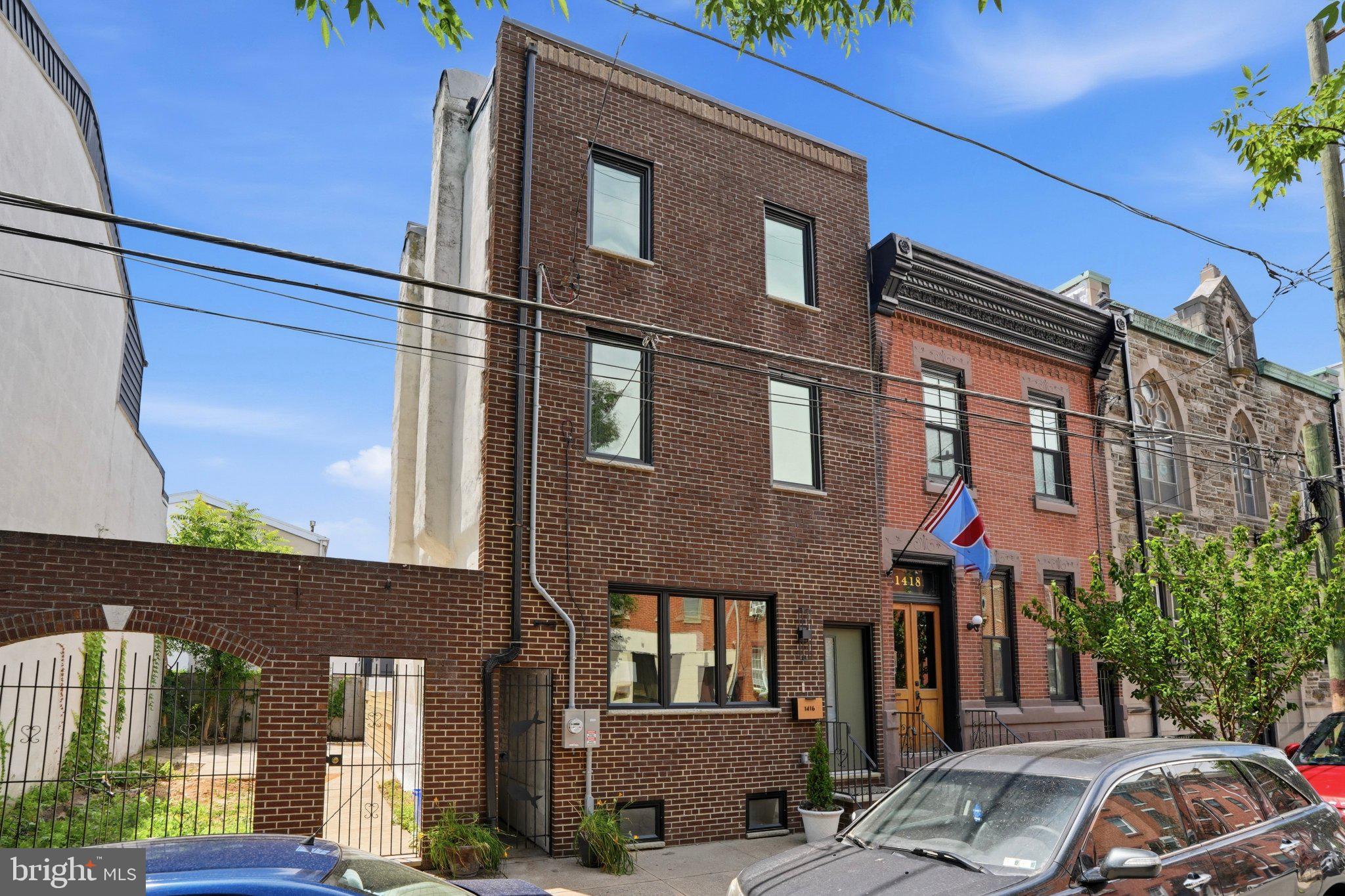 Welcome to 1416 E Susquehanna Avenue — a standout newly renovated home on arguably one of the best blocks in Fishtown, perfectly positioned across from Hotel Anna & Bel and designed by Studio Sigi. This 4-bedroom, 3.5-bath residence delivers a rare blend of architectural intention, elevated finishes, and warm, modern livability at an
exceptional value.

Step inside to an expansive open-concept main level where oversized windows flood the space with natural light, highlighting the seamless flow between the living, dining, and kitchen areas. The kitchen is truly the centerpiece, featuring a striking oversized island, Taj Mahal quartzite countertops, custom cabinetry, and a refined, timeless design palette. A conveniently located powder room and main-floor laundry add to the home’s effortless functionality.

The finished lower level offers incredible flexibility, complete with additional living space, an egress window, and a one-of-a-kind wine cellar tucked into the home’s original coal room — a charming and unexpected feature perfect for entertaining or private collections.

Upstairs, the second floor includes three generously sized bedrooms and two full bathrooms, ideal for guests, family, or work-from-home setups. The entire third floor is dedicated to a stunning primary suite retreat, featuring a wet bar, a spacious bedroom, a spa-like bathroom with a soaking tub and walk-in shower, and direct access to a private terrace —
your own private outdoor escape in the city.

Thoughtfully equipped with modern conveniences, the home includes keyless entry, Nest thermostats, built-in speakers, and custom lighting throughout, blending smart functionality with elevated design.

With a full 10-year tax abatement and a prime location surrounded by Fishtown’s best dining, cafés, and neighborhood hotspots, 1416 E Susquehanna Avenue offers the perfect combination of style, comfort, and long-term value.