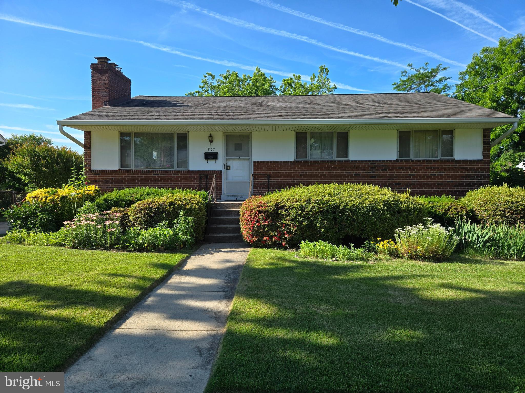 This delightful rambler is nestled on a spacious 0.20-acre lot. The home features 3 bedrooms and 2 bathrooms on the upper level, while the basement includes 1 bedroom, a full bath, a den, and a fireplace, perfect for cozy gatherings.  Main level highlights include a bright front living room with a charming wood-burning fireplace, a dining room with direct access to a sunroom, and beautiful hardwood floors throughout. Additional features include driveway parking and a large, flat backyard, perfect for outdoor activities. The property boasts freshly painted interiors, a modernized kitchen and bathroom, and newly renovated basement flooring. Its prime location means you're just minutes away from the Wheaton Metro, Westfield Mall, Brookside Gardens, local parks, and major commuter routes such as Georgia Ave, Connecticut Ave, and I-495.
