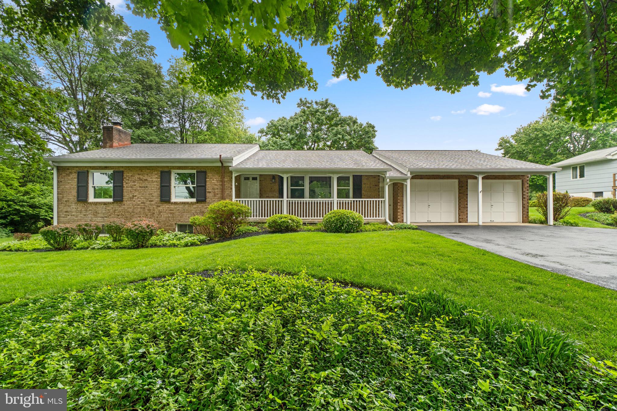Inviting ranch-style residence offering 2,227 square feet, 3 bedrooms, 2 full baths, 1 half bath, and a 2-car garage, all set on over an acre in tranquil Indian Hills. A charming front porch and manicured landscaping welcome you into the updated interior, where the foyer opens to combined living and dining rooms featuring luxury vinyl tile flooring, a striking white brick accent wall, and a large picture window that fills the space with natural light. The spacious eat-in kitchen is outfitted with crisp white cabinetry, stainless steel appliances, and connects seamlessly to a sunroom showcasing vaulted ceilings, skylights, a brick accent wall, and slider doors that lead to the backyard—perfect for indoor-outdoor living.

Three main-level bedrooms include the primary suite, which boasts double closets and a private ensuite bath. A second full hallway bathroom serves the additional bedrooms. The fully finished lower level offers expansive entertaining space, including a recreation room with a brick surround gas fireplace and built-in wet bar, a game room, a versatile bonus room, a laundry room, and a powder room. Outdoors, the one-acre lot is framed by mature pine trees and features meandering stepping stone pathways leading to a deck ideal for dining al fresco. The yard also includes a swing and a charming well, creating a peaceful, storybook setting.