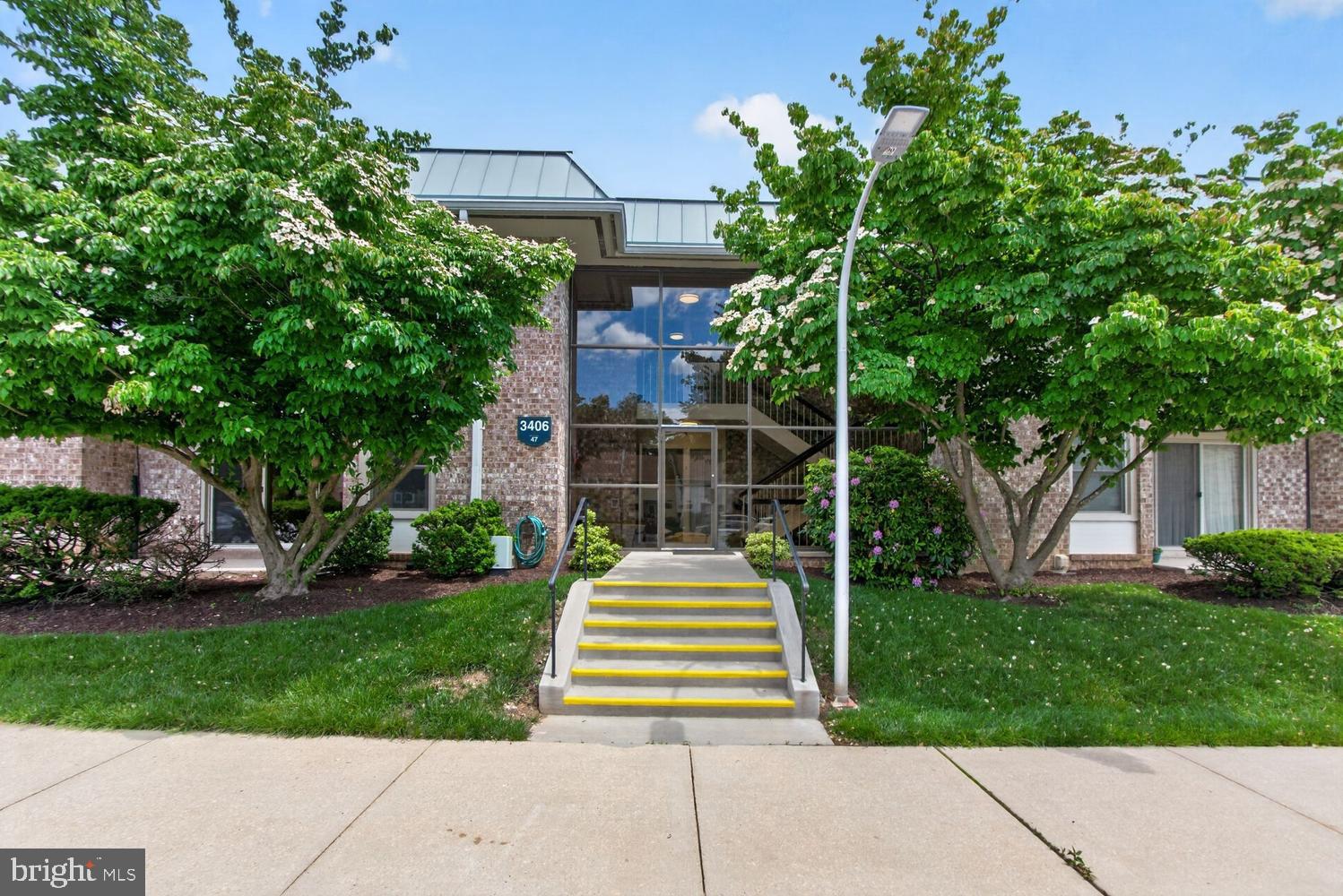 Incredible value in age 55+ community! This lovely co-op unit has everything you need plus fantastic amenities! This 800-sq ft 1-bedroom unit lives large. It features a spacious living room with a sliding door to a patio, dining room, galley kitchen, bedroom with a customized closet, and an updated bathroom. This Burgess model is on the main level, with just 6 steps into the building. The unit is freshly painted and has new flooring throughout. Across the hall is a full-sized washer and dryer that is shared with the other 3 units on the same floor. A large storage unit is on the lower level. One parking space is assigned. The monthly fee includes electricity, water, trash, cable TV, Internet, property taxes, most maintenance (including coverage for HVAC and appliances), security and the amazing community amenities. This well-established community is gated, and has a golf course, fitness center, swimming pools, pickleball/tennis courts, restaurants, art and fitness classes, clubs and activities, and more - resort-like living at its best!