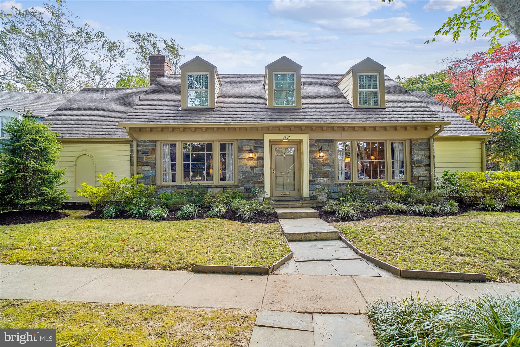 Finally, a highly sought-after charming stone front Cape Cod style home with a main level primary bedroom suite and a 2-car side load garage on a beautiful corner lot within the Overlook community.  Welcoming foyer entry, an expansive formal living room (with bay window and gas fireplace), a formal dining room (with bay window), the main level primary bedroom suite (with bay window, walk-in closet and updated full bath), renovated powder room/half bath, a family room open to the breakfast room & den area (with 2-sided gas fireplace, vaulted ceilings and wall of windows/sliders), updated kitchen (with new flooring, recessed lights and granite countertops) and exit door to the 2-car garage.  Enjoy backyard entertaining on the private expanded slate terrace with reservoir views!   The upper level encompasses 2 generously sized bedrooms with updated ensuite full baths and a walk-in hall closet.  The lower level has a large recreation room (with new flooring), an updated full bath, a laundry room, and a large storage room.   Other amenities/upgrades include the new HVAC system (gas furnace & central air), hardwood floors throughout the main & upper levels, and the freshly painted exterior.  The Overlook community is tucked within the Westmoreland Hills subdivision.  It has a neighborhood pool, playground, neighborhood events, scenic trails & walking paths, plus access to the Capital Crescent walking/biking trail.  The yearly Overlook HOA fee is $1,950.