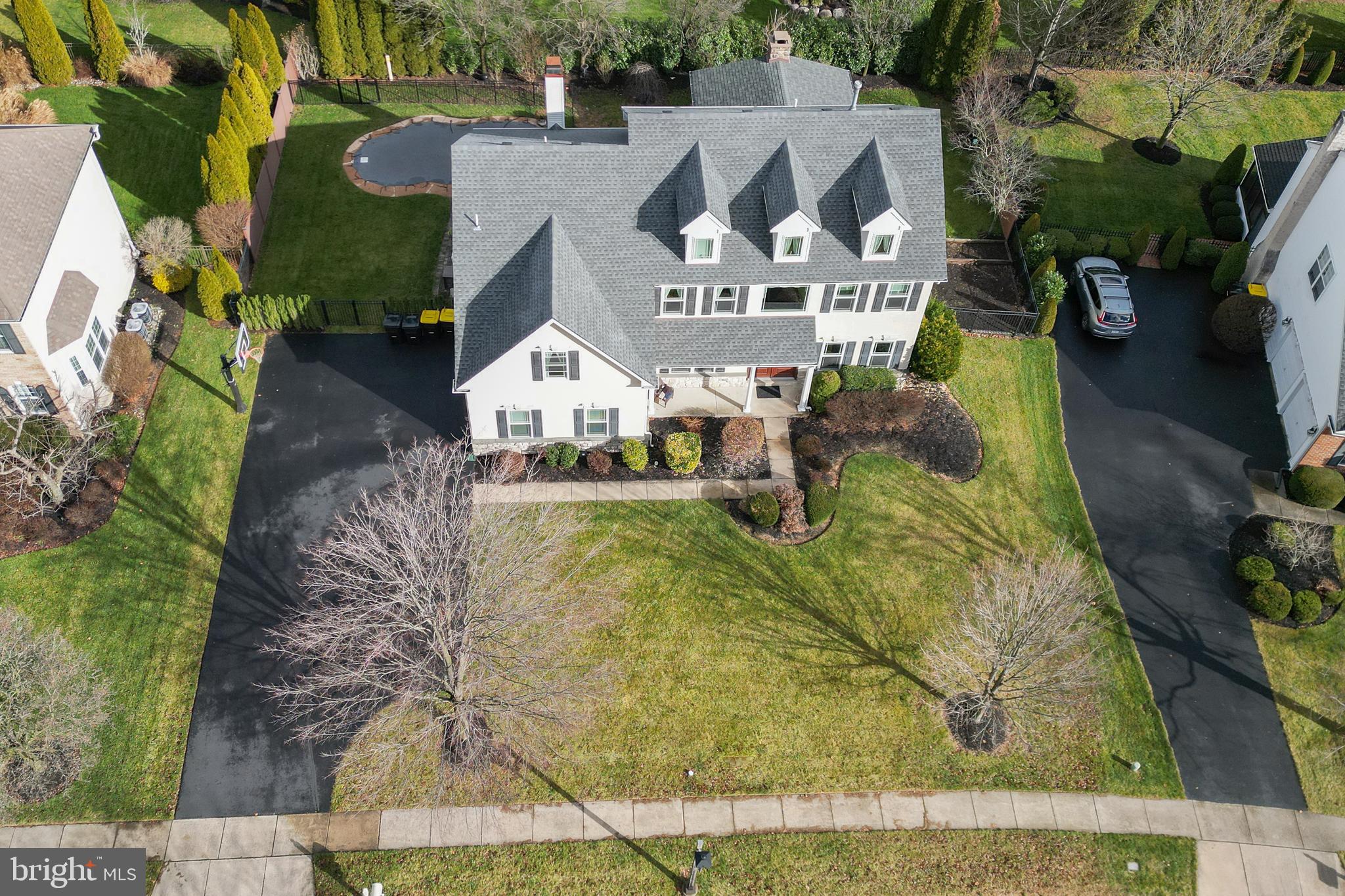 STOP LOOKING, YOU HAVE FOUND YOUR NEW HOME!!!! Move right in to this magnificent 4 bedroom, 2.5 baths home in Montgomery Crossing , a highly sought after neighborhood in award winning North Penn School District. The sellers added over $300,000 in upgrades and you will be amazed, it looks like something in a magazine! New Roof, Windows, HVAC, Finished Basement, Covered Pavilion with fireplace, Heated Saltwater  Pool , New Kitchen Cabinets, Fencing, Flagstone Patio , Outside Lighting,  and Landscaping!!! 
This move-in ready home is a FABULOUS  blend of indoor and outdoor living ,  perfect for those who enjoy entertaining and relaxing. 
Full finished  basement brings the total living area to over 4000 square fee
 SPECTACULAR pool and custom built outdoor covered pavilion with stone fireplace , built-in cooking area with a Lynx grill  and side burner included, large flat screen hook up,   paver flooring and plenty of space to enjoy watching your favorite sports with family and friends all year long! 
Enter the home into a two story foyer with an expanded  turned staircase and beautiful  hardwood flooring throughout, even the staircase and railing has  been replaced !  To your left is a large FIRST floor office/study  for all your computer and office needs. To your right is a living room and dining room with lots of custom upgraded millwork, perfect for entertaining family and friends. Gourmet kitchen is a chef's delight with 42" beautiful new white cabinets with glass front,  stainless steel appliances, recessed lighting, granite countertops, and spacious center island with breakfast bar. A desirable open concept is found in the kitchen which adjoins the breakfast area and family room.  Sliders off the breakfast room lead to the most AMAZING salt water pool and huge covered pavilion for entertaining,  landscaped beautifully by Rhoads Garden. and includes underground irrigation!  The pool and backyard are both fenced for privacy. The vaulted family room is spacious with floor to ceiling windows flanked by a gas fireplace. and beautiful wainscoting. There is also a  secondary staircase  that leads to the upstair bedrooms. The first floor is completed with a powder room, mudroom and oversized 2 car garage. As you step up on the newer  hardwood steps and wrought iron railings you will find the most LUXURIOUS primary bedroom suite to relax and unwind, you won't want to leave!! Primary bedroom suite has a cathedral/vaulted ceiling, hardwood flooring , and  is stunning!  That's not all... a  sitting area was configured into a HUGE closet  outfitted with cherry cabinets and drawers,  recessed lighting and shoe racks,  professionally designed.  Spa-like bath  with vaulted ceiling,  jetted tub,  double sink vanity, walk-in shower,  and tiled flooring. You will fall in LOVE with this bedroom suite!!! There are 3 additional bedrooms and a full hall bath that completes the second floor.  Magnificent newly finished lower level includes a bar area  with stools, quartz countertop, stainless steel appliances, ice maker, pendant lighting, a third fireplace, gym and large room with many possibilities for an additional family room or another office.  All these wonderful features are ideal for entertaining. A raised garden area is on the right side of the house, waiting for you to plant something special.   Close to shopping., restaurants, fitness centers, community parks, train, and minutes to major highways. Don't miss your opportunity to own this truly amazing home. Push the movie camera icon on the top of the page to see a video of this home.