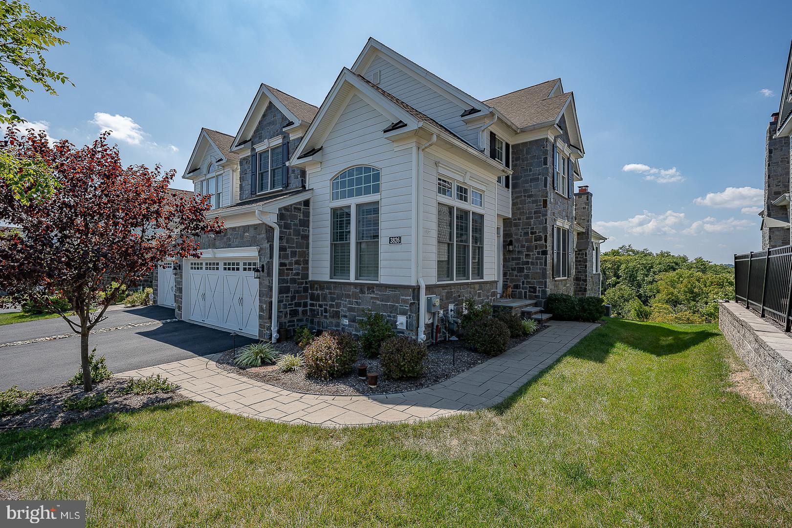 Welcome to 3826 Meadow View Farm Rd, an exceptional end-unit carriage home in the sought-after Liseter community. Situated on a premier perimeter lot, it offers a walk-out basement and spectacular views of the Liseter Preserve.  This move-in-ready “Bucknell” offers 3 Bedrooms, 3.5 Baths, and an array of upgrades that combine elegance with modern comfort. Highlights include premium lot placement, solid core doors, Anderson windows, hardwood floors, an expanded Garage, a Sunroom addition, a grand Primary Suite, a first-floor Office, and 2 Bedrooms each with an en-suite Bath.  There are plantation shutters throughout giving the home a fresh, crisp, and up to date feeling.
Step inside to discover beautiful hand-scraped hardwood flooring, custom millwork, chair rails, deep baseboards, and crown molding setting the tone for elegant living.  The first floor features a spacious Office with vaulted ceiling and French doors, ideal for working from home. The Dining Room is to the right of the Foyer with a soaring 2 story ceiling.  The gourmet Kitchen is a chef’s dream, equipped with off-white Century cabinetry, stunning gray granite countertops, JENN-AIR appliances, a 6-burner gas range, a large double door pantry with custom shelving, and an oversized center island with seating for 3 perfect for comfortable family dining and for entertaining.
The inviting Great Room, with its vaulted ceiling and cozy gas fireplace, invites relaxation, while the adjacent Sunroom is bathed in natural light and offers access to a serene Deck. Just off the Great Room is the first-floor Primary Bedroom Suite, featuring a tray ceiling, luxurious ensuite Bath with seamless shower, double sink vanity, and a custom walk-in closet. This level is completed by a convenient Laundry Room, Powder Room, and inside access to the expanded 2-Car Attached Garage which includes a 50 amp/240 volt electrical service, ideal for owners that have an electric vehicle. 
Upstairs, you’ll find a large versatile Loft space, ideal for lounging, play, or hobbies. There are two additional comfortable Bedrooms, each with walk-in closets and access to an ensuite Bath. The unfinished Basement, is an open canvas to create what you want, already plumbed for a Bathroom, it provides walkout access with sliders and double windows, offering endless possibilities for customization.
Enjoy outdoor entertaining on the Deck just off the Sunroom, complete with a remote-control retractable awning for shaded comfort on sunny days. The exterior is beautifully landscaped and maintained by the community as part of the monthly HOA fee, and an irrigation system ensures the greenery stays lush.  Additional amenities include a convenient central vacuum system, built-in wall speakers in the Dining Room, Great Room & Sunroom, a security system, and an interior sprinkler system for added safety.
The Liseter community offers resort-style amenities, including a clubhouse with game room, infinity pool, tennis courts, basketball courts, bocce courts, pickleball court, fitness center, and walking trails. Located just minutes from shopping, dining, and entertainment options in Newtown Square and nearby Wayne ensuring a convenient and enjoyable lifestyle for residents. It also offers easy access to major highways and public transportation for commuting to Center City Philadelphia and to the Philadelphia Int'l Airport.
This exceptional home seamlessly blends luxury, comfort, and timeless style. Don't miss the opportunity to make this exquisite property your own and experience the refined living in the Liseter Community.