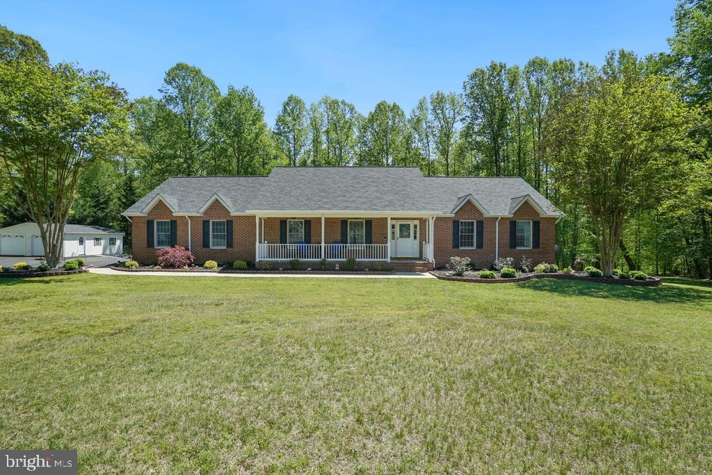 If your heart is where your home is, this 2001  custom built rambler is not
your average cookie-cutter home; but, rather a unique , one-of-a-kind
design; nestled on 3.2 acres and backing to woods with paths leading to a
flowing creek, it offers 3,500 sq ft of living space, four bedrooms, and three full
baths, plus a full walk-out basement with an in-law apartment complete with
separate entrance, kitchen, and laundry—perfect for multi-gen living or potential rental
income. The original owners have ensured that their pride of ownership transcends
every aspect of their home. Also showcasing an oversized flex area, huge walk-in
cedar closet and plenty of storage space for all. Also in the basement you will
appreciate the fully finished mechanical room with an oversized well tank and core
utilities. The basement includes a 2nd separate stairway leading up to the 2
1/2 car - attached garage which is brightly lit and has a concrete floor sealant. A huge bonus is the detached 24 x 28 Amish-built shed garage with electric. Additional highlights include an energy-efficient 4-zone geothermal heat pump with a "desuperheater" and preheat water tank for almost limitless abundant hot
water, Anderson tilt-wash double-hung argon filled windows with argon and energy
efficient Low-E glass, large "over garage" attic with built in shelving and full access
stairwell, Quartz and granite counters in the kitchen and baths, central vacuum, water
softener, concrete patio, driveway entry alarm, heat and glow gas fireplace, extensive
up-to-date remodeling (2025- a new extended driveway, 2024 - new hardwood floors,
two remodeled bathrooms, 2023 - new roof with designer architectural shingles, 6- inch
gutters, shutters, new garage openers and full home landscaping with yard lighting;
2021 - MIL remodel; 2019 - replaced and upgraded geothermal heat pump; 2015 - kitchen remodel ), and a location close to military bases, shopping, restaurants, schools,
and the library, making your tour a truly extraordinary, one-of-a-kind experience.