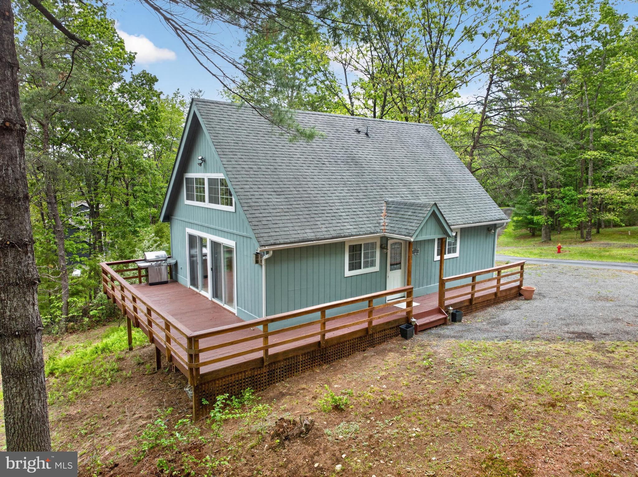 Welcome to your dream retreat! This beautifully maintained Chalet has 2 Bedrooms, 2 Baths plus a Large Loft and offers a perfect blend of comfort and charm, nestled above a serene private lake with year-round views of Great North Mountain.
As you approach, you'll appreciate the freshly painted siding and stained decking. Step inside to discover the cathedral ceilings adorned with exposed beams and a wall of windows that fill the space with natural light and the wooded view with the mountains beyond.
The Great Room features a stunning stone gas fireplace, perfect for warming up on chilly evenings,  The kitchen has well maintained cherry cabinets and stainless steel appliances.  On the first floor, you'll find two bedrooms and a full bath, with laundry located  in the larger bedroom. A spacious storage closet under the stairs houses the tankless hot water heater, ensuring efficiency and ease of access. 
In the loft you will find a large open bedroom with two built-in beds and ample space for a queen size bed or a perfect hang out area.  The loft also includes a full bath with walk-in shower.
The home sits on a level lot with plenty of space for outdoor entertaining, whether you envision a fire pit for cozy gatherings or an expansive area for hardscaping and recreation. Located just minutes from  all of Bryce Resort's amenities, you'll have access to ski, golf, mountain biking, tennis, hiking, swimming and a plethora of outdoor activities to enjoy. 
This quaint cabin is the perfect getaway, less than 2 hours from the DMV and DC,  Don't miss your chance to own this charming chalet at Bryce's 4 Season Resort!