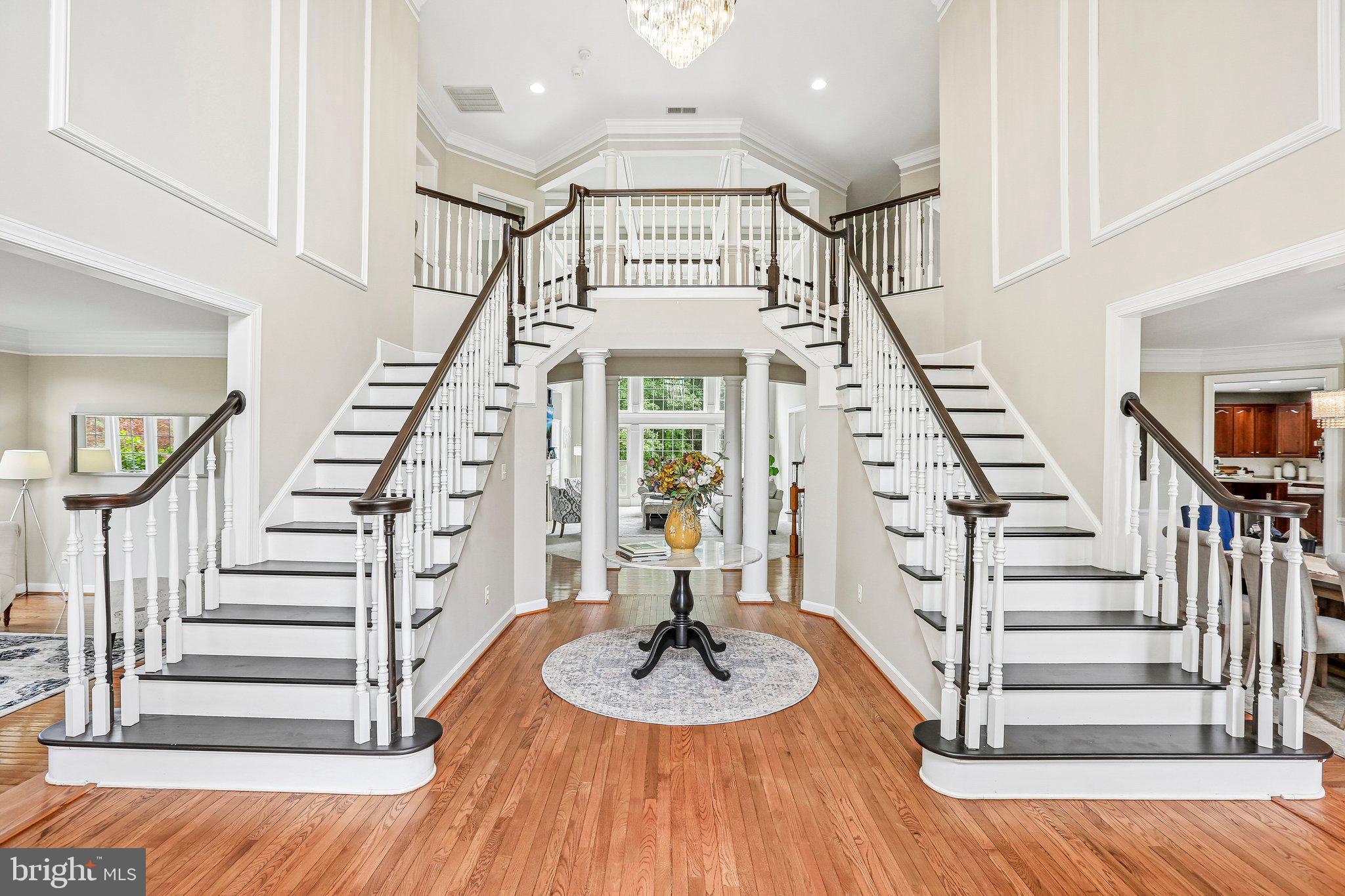 *** Newly zoned to Damascus High School**** Check it out with MCPS! If you've ever dreamed of living in a home that makes a grand first impression, prepare to fall in love. Welcome to NV Homes' coveted Monticello model, where timeless elegance meets everyday comfort.
From the moment you step through the front door, you'll be captivated by the dramatic two-story foyer. A magnificent double staircase sweeps gracefully upward, framed by elegant columns and connected by an impressive overlook bridge that creates a truly unforgettable entrance.
Rich hardwood floors lead you into a thoughtfully designed main level where every room invites you to linger. The expansive floor plan offers everything today's discerning buyer desires—a gourmet kitchen, sun-filled morning room, stunning solarium, and a private office adorned with beautiful custom built-in cabinetry.
At the heart of the home lies a breathtaking two-story great room that perfectly balances grandeur and warmth. A soaring wall of windows floods the space with natural light, while the exquisite coffered ceiling adds architectural depth, craftsmanship, and sophistication. Whether hosting elegant gatherings or enjoying quiet evenings at home, this remarkable room is destined to become your favorite place to be.
Upstairs, you'll discover four generously sized bedrooms, each featuring its own ensuite bath. Most offer walk-in closets, and three bedrooms feature new carpeting. The primary suite is truly exceptional—a private retreat designed for relaxation and luxury. A charming sitting room with custom built-in shelving provides the perfect place to unwind, while the sleeping area showcases a beautiful tray ceiling.
The primary dressing room and walk-in closet deserve special recognition. This boutique-inspired space features dual-sided hanging areas, abundant storage solutions, and a stunning arched window that fills the room with natural light. This is far more than a closet—it's a luxurious dressing suite designed to make organization effortless and everyday living extraordinary.
A convenient rear staircase leads directly back to the kitchen and great room, seamlessly connecting the home's living spaces.
The lower level is where entertainment takes center stage. An expansive bar and serving area offers everything needed to host unforgettable gatherings and could easily function as a second kitchen for multigenerational living. There is ample space for billiards, dining, game nights, and casual lounging in the spacious recreation room.
Movie lovers will be thrilled by the dedicated theater room, creating a cinematic experience right at home. A versatile bonus room provides endless possibilities as a fitness studio, home office, hobby room, or creative space. Completing this level is a full bath with convenient dual access from both the hallway and the private fifth bedroom, making it ideal for guests, extended family, or an au pair suite. The exceptional living spaces continue outdoors. Situated on a private two-acre homesite backing to mature woods, this property offers a peaceful setting with plenty of room to relax, play, and entertain.
Two spacious decks provide the perfect place to enjoy morning coffee, host summer gatherings, or simply take in the beauty of the surrounding landscape.
The three-car side-entry garage opens into an oversized mudroom and laundry area designed for everyday convenience. Complete with built-in storage, cubbies, hooks, and a private powder room, this thoughtfully designed space keeps everything organized while providing a practical transition into the heart of the home.
This extraordinary residence offers the perfect blend of elegance, comfort, and functionality. Every detail has been thoughtfully designed to create a home that is as impressive as it is inviting.
New school zoning to Damascus High School and Hallie Wells. Students can start now at Hallie Wells or DHS thru the Jumpstart program. Please verify all info with MCPS.