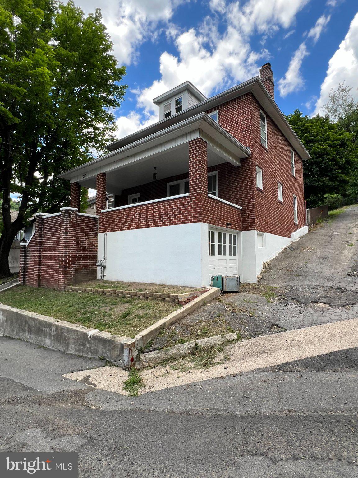 This home went from diamond in the rough to a DIAMOND! Come and see the sparkle in the stunning turn around in this home!. Solid brick home, with hardwood floors, 2 fireplaces. Sparkling new kitchen with adjacent mud/laundry room. Patio out back with a fully fenced yard. Large front porch with superb views of the city and the WV skyline. Lots of room here in an affordable package. Come and see for yourself! Convenient to all town amenities! Bring on the offers!