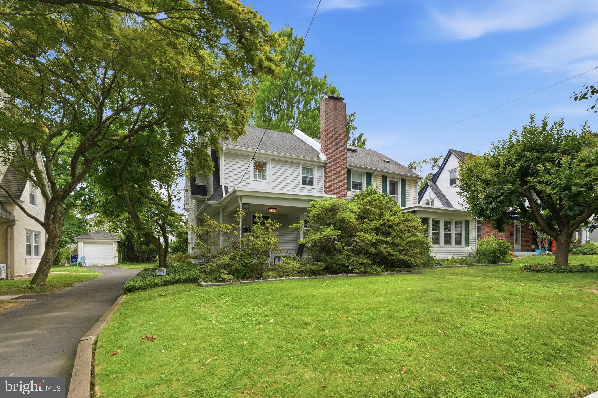 Welcome to this charming twin home nestled on a picturesque, tree-lined street in the highly desirable Rowland Park section of Cheltenham Township. From the moment you arrive, you'll appreciate the inviting covered front porch—an ideal place to relax and enjoy the peaceful neighborhood setting.

Step inside to discover beautifully exposed hardwood floors with stunning herringbone inlays, complemented by fresh paint throughout, creating a warm and timeless feel. The spacious living room is flooded with natural light and features a classic wood-burning fireplace, making it the perfect gathering space. Continue into the elegant formal dining room highlighted by a beautiful chandelier, ideal for entertaining family and friends. Just beyond is a convenient breakfast room/eating area and a well-appointed kitchen offering an abundance of cabinetry and countertop space, complete with a gas range with hood, built-in stainless steel dishwasher, and refrigerator included.

The second floor features a spacious primary bedroom with ceiling fan and private rooftop deck, providing the perfect retreat for morning coffee or evening relaxation. Two additional generously sized bedrooms and a beautifully maintained three-piece ceramic tile bathroom with a soaking tub/shower combination and attractive subway tile surround complete this level. The third floor offers a large fourth bedroom with ceiling fan, ideal for guests, a home office, or additional living space.

The finished lower level expands your living area with a comfortable family room that also offers excellent storage possibilities, a convenient powder room, separate laundry room with washer and dryer included, and walk-out access to the rear yard.

Outside, you'll find a nicely sized backyard perfect for entertaining, gardening, or pets, along with a private driveway providing valuable off-street parking. Additional improvements include newer replacement windows, brand-new siding, and a brand-new roof, offering peace of mind for years to come.

Ideally situated in one of Cheltenham's most sought-after neighborhoods, this home is served by the highly regarded Cheltenham School District and offers exceptional convenience to Center City Philadelphia, major highways including Route 309, the Pennsylvania Turnpike, and I-76, as well as SEPTA regional rail and bus service. Enjoy easy access to nearby shopping, parks, local dining, and countless neighborhood amenities. Combining classic character, thoughtful updates, and an unbeatable location, this is a home you won't want to miss.