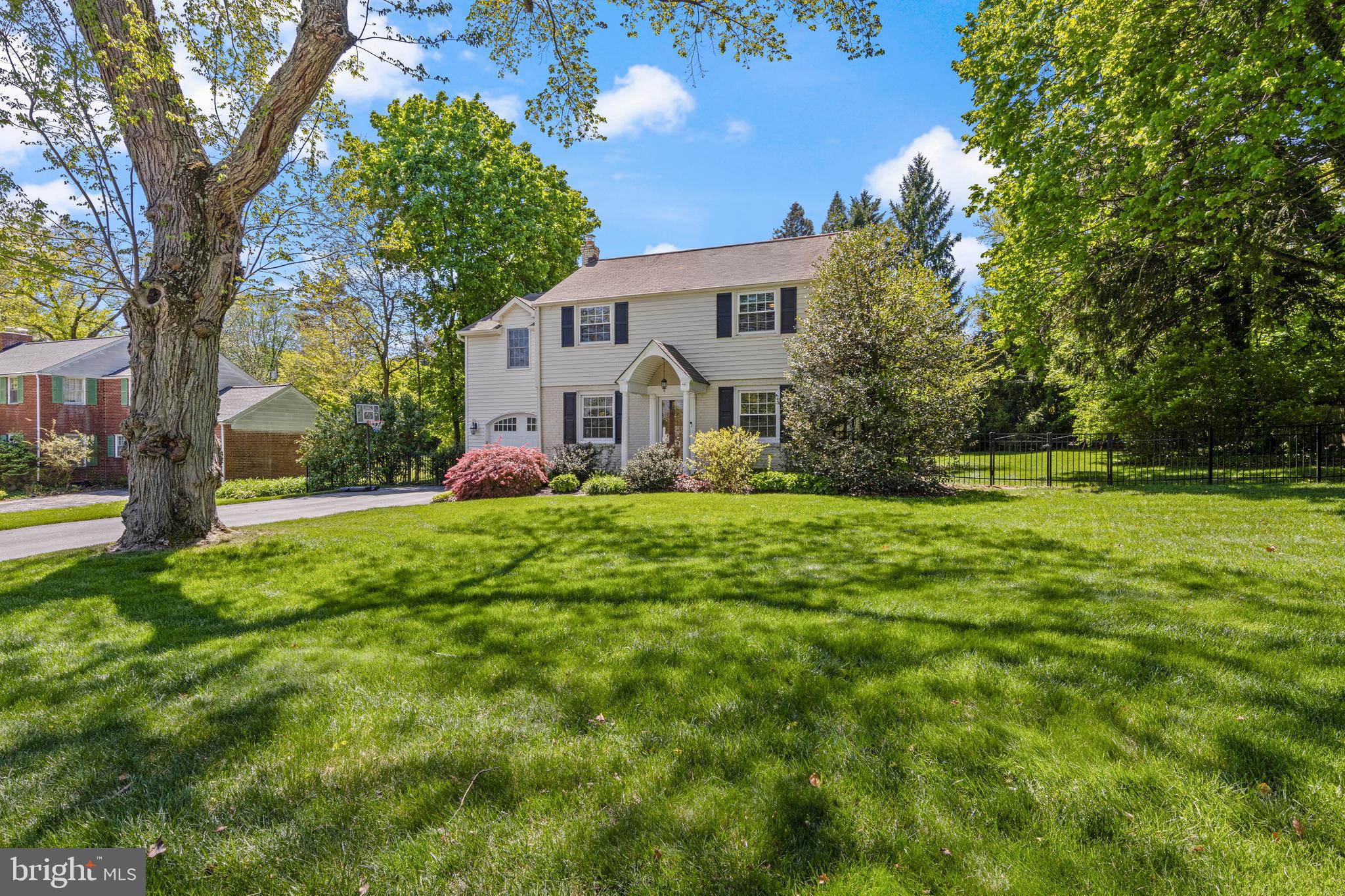Welcome to 290 Wentworth Road, a beautifully maintained 5-bedroom, 3-full-bath brick and siding Colonial in the highly sought-after Tredyffrin/Easttown School District. Situated in the heart of the popular Dunn Hill neighborhood, this home offers the perfect combination of Main Line charm and modern updating. The property welcomes you with exceptional curb appeal, featuring an arched garage entry, an inviting front porch, and a beautifully landscaped, level lot.
Step inside to the front living room featuring hardwood floors and a gas fireplace. Arched doorways lead to the open-concept dining area and kitchen, while to the right of this room is the staircase to the upper level as well as a door leading to the family room, ensuring the open floor plan living today’s buyers desire. The kitchen has classic cabinetry, light granite countertops, white subway tile, an undercounter wine/beverage refrigerator, and recessed lighting. A peninsula island with pendant lighting accommodates seating for two, and a unique see-thru opening above the sink provides convenient views into the family room, keeping you connected while preparing meals. Natural light floods the adjacent dining area, and just off the kitchen is the expansive family room. This show-stopping room features vaulted beamed ceilings, recessed lighting, and a wood-burning fireplace with a stunning neutral brick surround. Custom built-in cabinets with a window seat flank the room, while sliding glass doors lead to the rear deck. A nicely updated tiled full bathroom, pantry, and mudroom with garage access complete this level.
The upper level is home to the primary suite, featuring a vaulted ceiling with a skylight, a walk-in closet with custom organizers, and a beautifully updated ensuite bathroom with a glass enclosed shower, double vanity, marble tile, and a large linen closet. Three additional, generously sized bedrooms are serviced by a tastefully updated and freshly painted hall bathroom with twin marble vanities and stunning tile work. A cozy fifth bedroom offers the perfect space for a home office; notably, 3 of the 5 bedrooms feature hardwood flooring. A convenient upper-level laundry room completes this floor. The finished lower level with tile flooring and built-in storage provides excellent bonus space, ideal for a second family room or play area. A good-sized utility room provides great storage space.
The exterior features a rear updated Trex deck overlooking a level, fenced yard with mature plantings and a new shed. The Dunn Hill neighborhood is a sought-after favorite, known not only for its super-convenient location walkable to  Wayne and convenient to everything the Main Line has to offer—but also for its active community association with holiday luminaries, block parties, and the annual Fourth of July bike parade! Enjoy an ideal lifestyle just a short walk to the Strafford Train Station (R-5) and a close walk to the Radnor Trail, Tredyffrin Library, and Strafford Park with its tennis courts, playground, and fields. You are just a quick drive to the upscale boutiques and restaurants of downtown Wayne, the Farmers Market, King of Prussia Mall, and major commuting routes. Experience the very best of Main Line living in a home that perfectly balances comfort, community, and convenience.