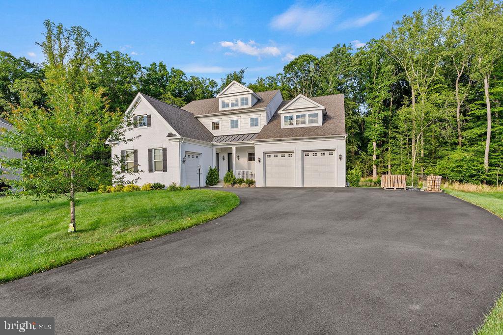 Welcome to a home that redefines multigenerational living, luxury entertaining, and everyday comfort. Perfectly positioned on nearly half an acre, this exceptional 5-bedroom, 4 full bath, 1 half bath residence offers over-the-top functionality paired with elegant design and one of the most sought-after floor plans on the market.

The true showstopper is the private main-level in-law suite, thoughtfully designed to live like its own residence. Complete with separate exterior and interior access and its own dedicated garage bay, this space is ideal for extended family, long-term guests, caregivers, or anyone seeking privacy without sacrificing connection.

At the heart of the home, the gourmet kitchen was designed to impress. Featuring premium Electrolux appliances, a 6-burner gas cooktop, pot filler, built-in microwave, wall oven, expansive cabinetry, oversized pantry and generous prep space, it effortlessly blends everyday functionality with entertaining appeal.

The luxurious primary suite serves as a private retreat, offering a massive walk-in closet and a spa-inspired bath with huge walk-in shower with dual showerheads, a double vanity sink with the bathroom highlighted by heated floors that provide year-round comfort.

The lower level continues the home's impressive versatility with a spacious finished recreation room, an additional bedroom and full bath, abundant storage, and a dedicated home theater experience featuring a 100+ inch projector screen and built-in surround sound speakers.

Step outside and discover what truly sets this property apart.  A spacious maintenance free trex deck that looks onto the covered pavilion.   The covered pavilion creates a resort-style outdoor living experience centered around a fully equipped outdoor kitchen featuring a built-in grill, griddle, sink, extensive counter space, ceiling fan and a heat lamp, allowing for comfortable entertaining throughout much of the year. Whether hosting game-day gatherings, summer cookouts, or quiet evenings with family, this space was built to be enjoyed. The outdoor living continues with a deck overlooking the backyard and a covered patio below, creating multiple spaces for relaxing, dining, and entertaining.

Surrounded by mature trees and thoughtfully designed indoor and outdoor living areas, 14855 Estella Lane offers the rare combination of luxury, flexibility, privacy, and multigenerational functionality that today's buyers are searching for but seldom find.