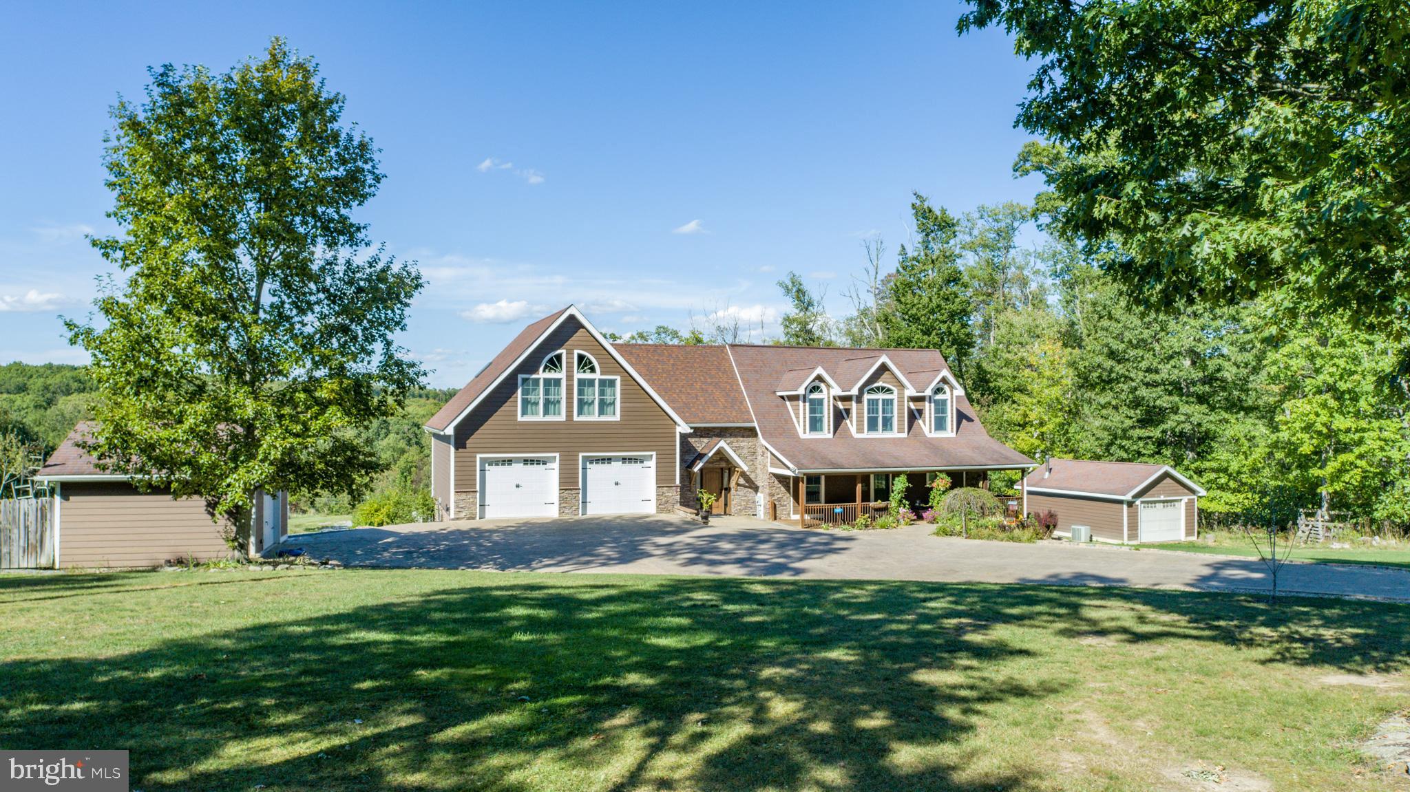 Welcome to a private retreat on 4 acres with sweeping views and a large front yard, just minutes from Deep Creek Lake and Oakland. This 4-bedroom, 4.5-bath home has been carefully updated to balance comfort, practicality, and modern style.

The main level features hardwood floors, radiant heat for added comfort, and open gathering spaces with quiet nooks for reading or hobbies. Upstairs, two primary bedrooms with private baths provide flexibility for family or guests. The full apartment-style basement includes its own kitchen, laundry, and heated floors, offering an inviting space for extended stays or independent living.

Outdoors, a stamped concrete driveway leads to an oversized two-car garage, with additional garages and sheds for storage or projects. A fenced in-ground pool, hot tub, and wood decking create a welcoming space for entertaining and relaxation.

With thoughtful upgrades throughout, extensive amenities, and close proximity to both town and lake, this property offers the best of convenience and privacy in one setting.