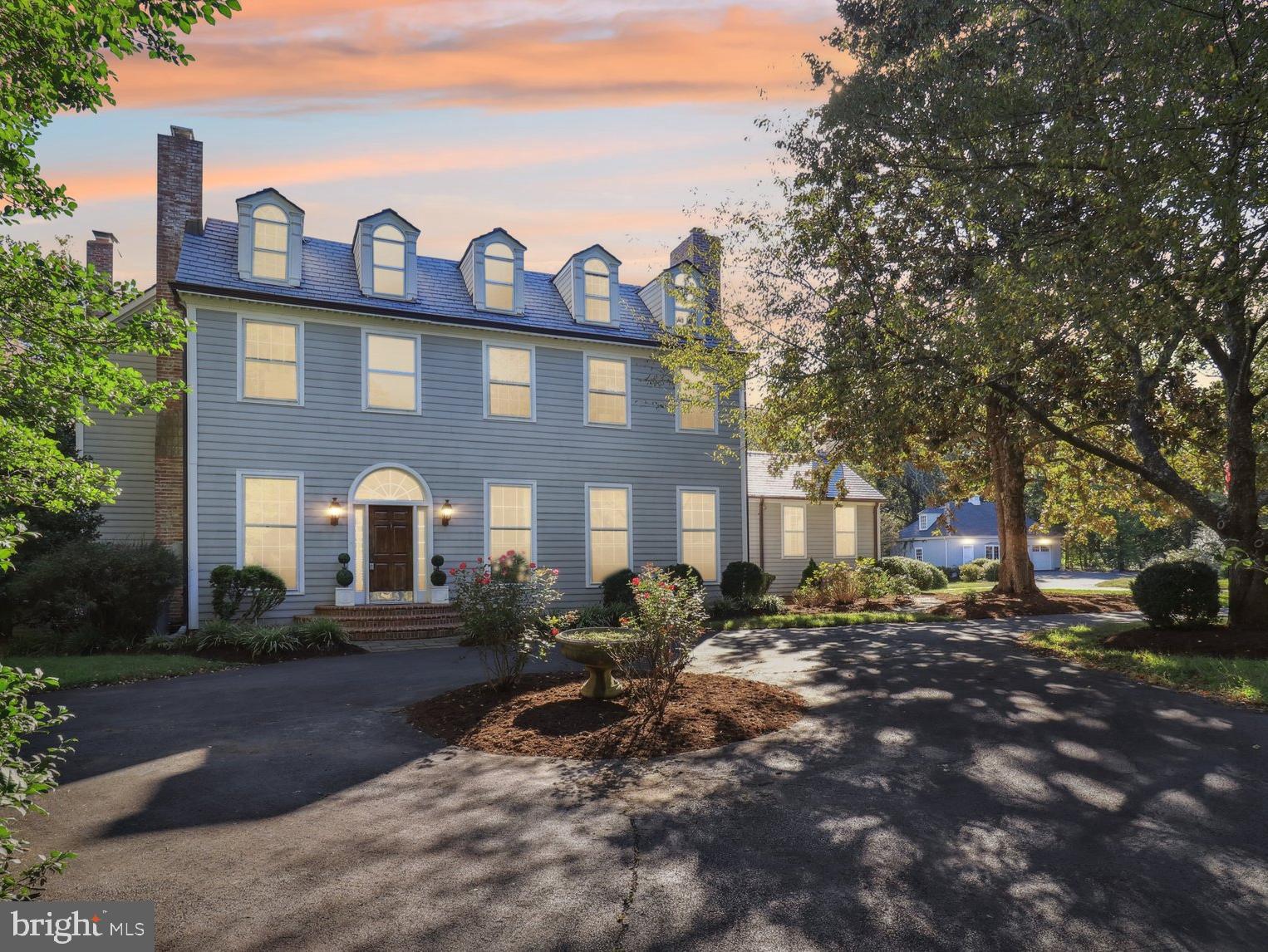 Beyond the private gated entrance, down a tree-lined driveway, lies your peaceful retreat - a beautiful historic estate located on 6.8 acres, nestled between Pohick Bay, George Mason’s Gunston Hall, and the Mason Neck State Park. An impeccable blend of modern updates and old-world character make this home perfect for both entertaining and everyday life. 

Be prepared to be impressed by the grand 14' ceilings, four fireplaces, wide plank hardwood floors, and exceptional trim and millwork throughout. Just off the foyer and through one of several large arched doorways, the wood paneled study highlights the incredible craftsmanship of the 100-year-old home. Both the living room and dining room provide gracious spaces for large scale entertaining that easily flows from room to room, where gatherings can spill out through the 10 sets of french doors to the expansive custom brick patio. 

The renovated kitchen addition blends seamlessly with the original home and offers vaulted ceilings, modern appliances, plenty of prep space, stone countertops, and wall to wall storage any chef would appreciate. Just beyond the island is a breakfast/keeping room, a warm and welcoming spot for enjoying a drink or casual meal by the fire. This area also serves as a convenient entrance when coming from the side driveway or garage and offers a large sink and functional workspace for tiding up after gardening or being outside. There is no shortage of activities to enjoy outdoors, both on and off property, with your own saltwater pool, private tennis court, barn, and the surrounding equestrian trails and parks.

Upstairs, the old and new continue in perfect harmony. Escape to the stunning Primary bedroom featuring views of the property from a Juliet balcony and a wood burning fireplace.  The renovated marble bathroom,  features multiple vanities, a spacious marble shower, laundry, and wall to wall closets.

A second bedroom with vaulted ceilings, accentuated by a crystal chandelier, and a Juliet balcony connects through a shared bathroom to another generous bedroom featuring an exposed brick wall. Tucked just off the landing is a cedar lined closet and another small set of stairs leading to the finished attic loft. This charming space filled with nooks and dormer windows has been used as a children’s playroom, office, and guest space over the years and has its own full bathroom.

Almost hidden on one side of the beautiful arched doorway between the foyer and living room is a door leading to the partially finished basement with walk up access to the side yard. In addition to finished and unfinished storage, there are two pool changing rooms, a full bathroom, and a laundry area/hookup, making life easy when you need to clean up after a swim or tennis.

Once part of George Mason's Gunston Hall estate, this land was given to a member of Mason's family and the stone walls of the original Springfield/Cockburn house (est 1763) serve as the foundation to the German bankbarn/garage today. The three-level structure is so much more than a garage, with stalls to house sheep, horses, and a tractor/mower on the lower level. The middle level serves as a workshop and garage and, along with the upper-level loft, has electricity and HVAC, providing potential for additional finished living space.

With all the tranquility and space this property offers, you may forget you are less than 4 miles from Rte 1 and 95 and only a 35 minute drive into downtown DC. Or you can choose to stay home and be as connected as you need with high-speed internet and a backup generator.

Welcome home!