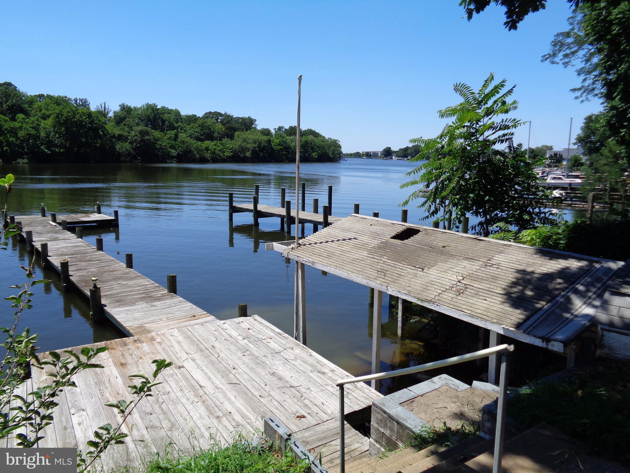 Charming Watefront Cottage on Bear Creek,across from SP Country Club.Freshly Painted w/ New Flooring Throughout. S/S Fridge and Propane Stove.Multiple sheds for boating equipment.Oversized one car garage (17' x 27') w/additional storage/crab shack.Partial Basement for Storage.Wonderful Outdoor Living! Awesome Shade Tree.Fantastic Watefront Views.6x12 deck;14x10 patio;70' Pier. Deep Water 5-6'