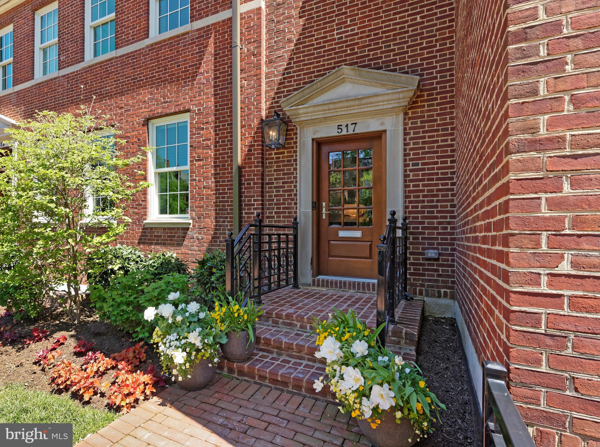 A historic brick building modernized to perfection is now available for your viewing pleasure at 517 N. Saint Asaph Street in Old Town!  This impeccable 3-story single-family residence has all the style and luxuries you could want in a new high-end home, from an elevator accessing all levels to a detached 2-car garage with EV outlet, storage, and studio with full bath above. A lovely landscaped fenced front yard and brick walkway optimize charm and curb appeal, while inside is sleek and stunning with an open floorplan and contemporary flair.  A dramatic entrance graced by an artful staircase greets your arrival, accented by an exquisite Timothy Oulton chandelier featuring crystals with metal rods creating a dazzling rainfall effect. The large, beautiful living room with a striking 2-sided gas fireplace sets an inviting tone for entertaining, with easy open dining for the host. Elegant wide-plank walnut floors enrich the ambience, and designer recessed lighting sparkles above. The chef's kitchen is a real showstopper, finely appointed with generous Snaidero Italian cabinetry, quartz countertops, premium stainless steel appliances by Thermador, and wine cooler for favorite vintages.   Open to the kitchen is a sun-bathed breakfast area brightened by a wall of windows and fabulous family room that shares the gas fireplace. Glass doors open to the rare, extraordinary, expansive private fenced rear terrace for the ultimate outdoor living, affording plenty of lounging/sitting and dining space. An alfresco outdoor kitchen with Urban Bonfire Canadian cabinetry, gas fire pit, tasteful lighting, and lushly planted oversized flower pots with rain gauges and irrigation heighten the experience. Inviting, well-proportioned bedrooms provide a comfortable place to land, offering walk-in closets and immaculate en-suite baths. The divine primary suite bath has upscale Waterworks fixtures, marble floors, a dual-sink vanity, spa shower, and freestanding soaking tub for unwinding. Other highlights of this beauty include a laundry room with sink, washer and dryer, and lower level with a media/TV room, kitchenette, bedroom (now an office), and full bath.   Located in quaint, coveted Old Town known for its timeless architecture, cobblestoned streets, plus great shopping, dining and amenities. Trader Joe's is just one block away, and an assortment of restaurants can be enjoyed within 3-4 blocks.