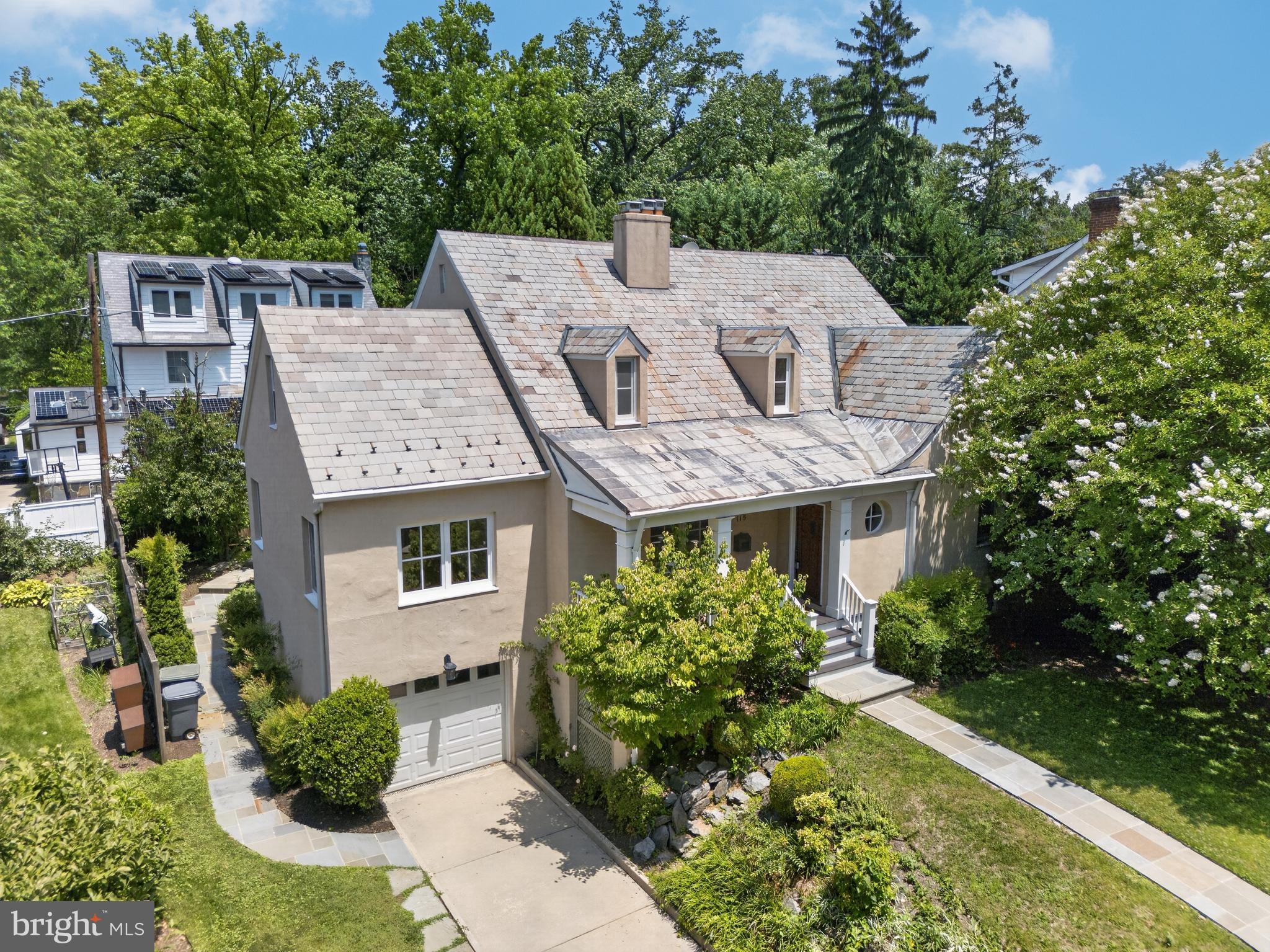 Singular. Gracious. Remarkable. You have a rare opportunity to own a home on one of Chevy Chase Village’s most desirable streets, just off Chevy Chase Circle. This distinguished residence blends timeless character with thoughtful updates in one of the Washington area’s most established and charming neighborhoods. The main level features a gracious layout with a formal living room and formal dining room that flow naturally into a bright, light-filled kitchen and living area combination. The kitchen features timeless European SieMatic kitchen cabinets. A main-level bedroom with an adjacent full bath adds wonderful flexibility. Completing the level is a spacious bonus room that opens seamlessly onto the covered rear porch, making it an ideal entertaining area, home office, or quiet study. Upstairs features a generously-sized primary suite with a custom designed full bath with heated flooring, steam shower, and ThermoMasseur soaking tub. The owner's suite also features a stacked washer/dryer and an adjoining room that can function as a library / office, dressing room, studio, or nursery. The lower level includes a finished living area, generous storage possibilities, and direct access to the one-car garage. European Tilt & Turn windows featured throughout! Outside, professional landscaping frames the property with a flagstone walkway leading to the welcoming front porch and a flagstone patio off the covered rear porch — ideal for quiet mornings or relaxed evening gatherings. A slate roof adds enduring character. Living in Chevy Chase Village is a true privilege. Residents enjoy the seldom-found combination of timeless, tree-lined streets, gracious custom-designed homes, and a genuine sense of community in one of Maryland’s most distinguished neighborhoods. With its own dedicated police department, proximity to Chevy Chase Club, walking distance to Friendship Heights Metro, and effortless access to Bethesda Row and Washington, DC, the Village offers an unmatched lifestyle of stability, convenience, and quiet distinction just minutes from the nation's capital. Properties on Grafton Street rarely come to market — an address that represents both prestige and lasting value. Schedule your tour today!