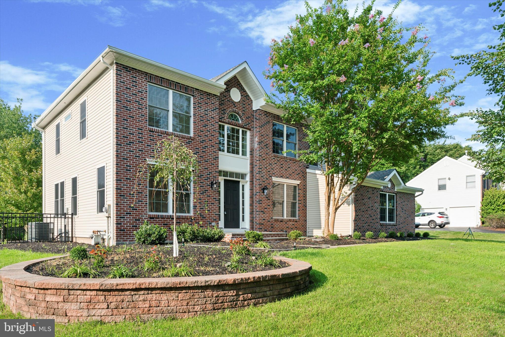 Step into elegance through a charming bluestone entrance that sets the tone for this exceptional home. The grand two-story foyer is enhanced by fresh landscaping, creating an inviting first impression. The Den  features French doors that offer privacy and a touch of sophistication. The Living Room/Dining Room is perfect for entertaining. This space offers convenient access to the basement and seamlessly flows into the heart of the home.  Culinary enthusiasts will adore  the kitchen with brand-new Kitchen Aid appliances, ample cabinetry, and quartzite countertops.  Cozy up by the fireplace in the adjacent family room, or step through double French doors into the expansive bonus room, which boasts a vaulted ceiling and abundant natural light, offering a versatile space for relaxation or recreation.  Enjoy outdoor living just off the kitchen and bonus room on the Timber Tech English Walnut deck, featuring a sleek drink railing—ideal for entertaining or unwinding in style. The revamped laundry room combines practicality with aesthetics, featuring a beautiful backsplash, generous counter space, and ample storage. New Maytag washer and dryer with pedestal enhance the convenience.  The entire first floor features wide plank luxury vinyl flooring throughout offering both durability and timeless appeal. The 2 car attached garage is equipped with EV charging station. The second floor has 4 bedrooms and 3 full baths.  The primary bedroom features a tray ceiling and a large walk-in closet with a window, offering ample storage. Pamper yourself in the luxurious owner's bath, complete with a large shower featuring a rainfall shower head, handheld wand, two niches, and beautiful accent tile. The double sink and makeup vanity provide added convenience and elegance. The larger hall bath is a well-appointed space featuring a large vanity with double sinks and a linen closet. This home offers a harmonious blend of style, functionality, and comfort, making it the perfect retreat for modern living.
