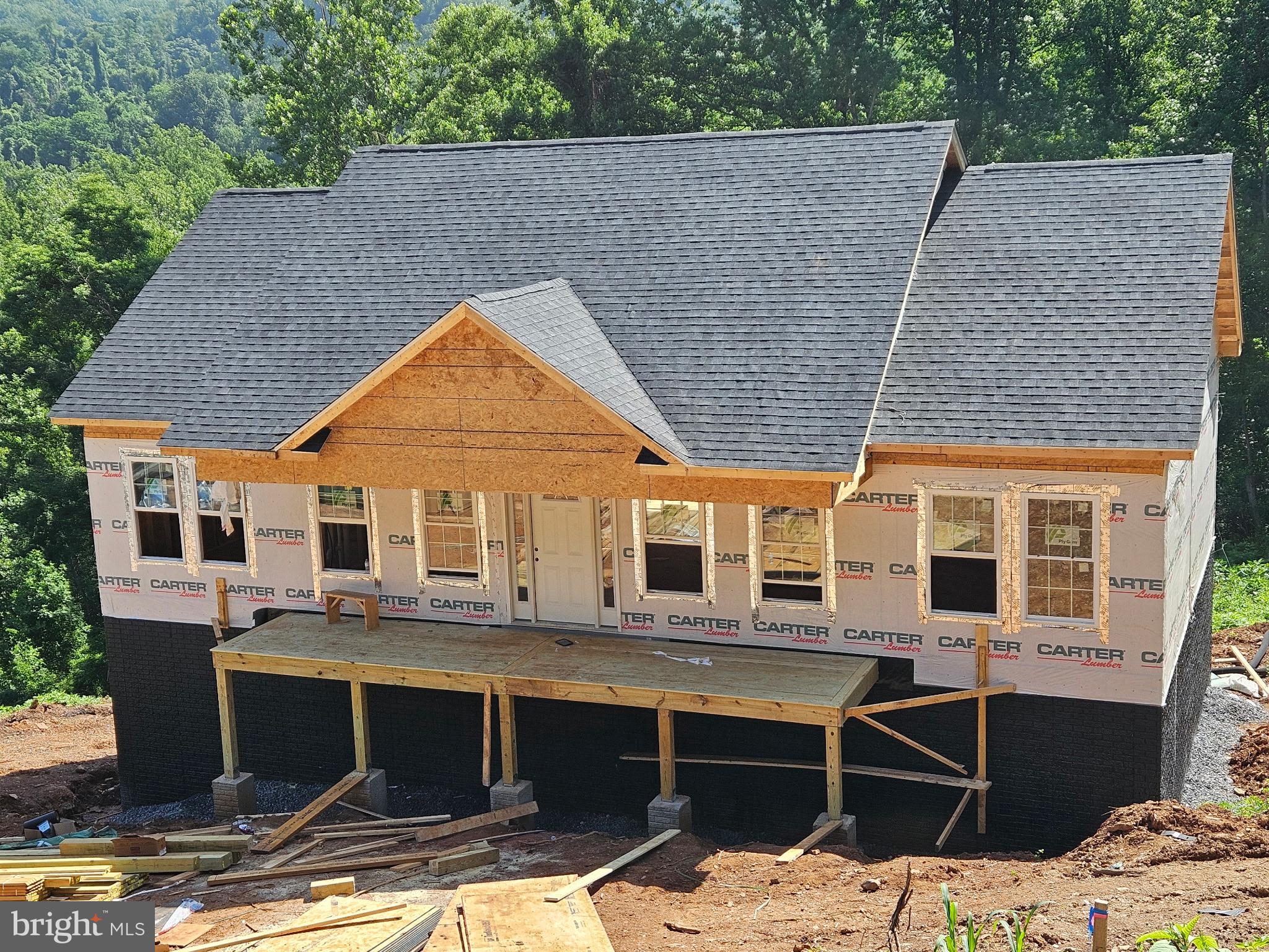 NEW CONSTRUCTION | LAKE ACCESS | READY SEPTEMBER 1ST

Discover the perfect blend of modern comfort and outdoor living in this brand-new home, scheduled for completion by September 1st. Situated on nearly a half-acre lot, this thoughtfully designed residence offers approximately 1,400 finished square feet above grade, plus a full unfinished walk-out basement with rough-in plumbing for a future full bath—providing the opportunity to nearly double your living space.

Inside, you'll find an open-concept floor plan featuring vaulted ceilings in the great room, dining area, and kitchen, creating a bright and spacious atmosphere. Luxury vinyl plank flooring flows throughout the main living areas, while ceramic tile accents the bathrooms. The kitchen is designed for both style and functionality, offering easy-close cabinetry, a center island, granite or quartz countertops (allowance provided), and a $4,000 appliance allowance.

The primary suite serves as a private retreat with a tiled shower, cultured marble vanity, and ceramic tile flooring. A second full bath features a tub/shower combination and ceramic tile flooring.

Exterior highlights include a covered front porch, rear pressure-treated deck with railings, architectural shingle roof, vinyl siding, underground electric service, 50-gallon water heater, and an energy-efficient 14 SEER heat pump. The walk-out basement is filled with natural light thanks to numerous windows and offers endless possibilities for future expansion.

Located just minutes from I-66 and I-81, this home provides convenient access to wineries, golf courses, hiking trails, shopping, and historic downtown Front Royal. High-speed internet availability makes working from home a breeze. Residents will also enjoy private lake access, community common areas, and endless opportunities for boating, fishing, and relaxation. One year builder warranty backed by DPOR