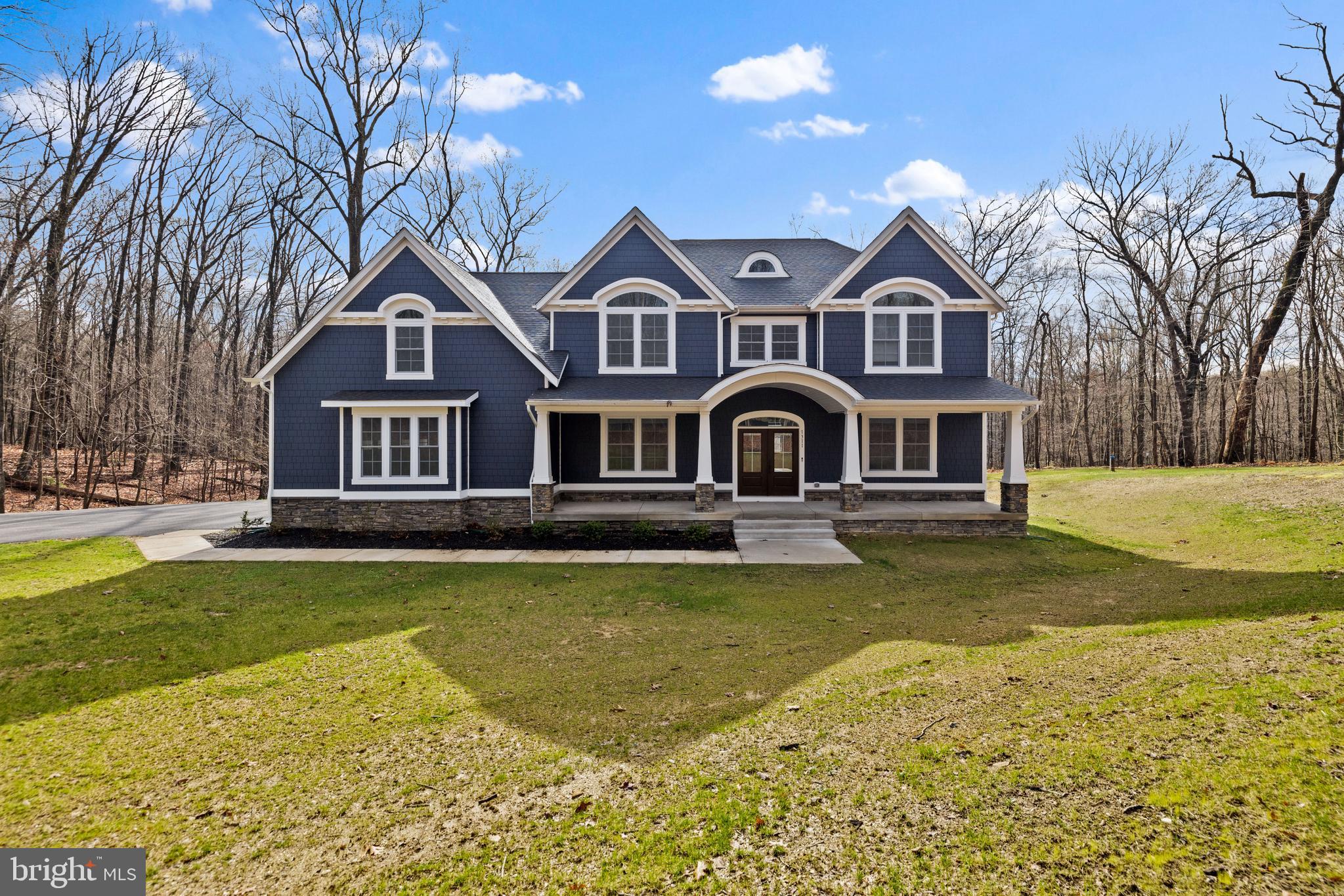 MOVE-IN READY! This stunning custom home by Greenspring Homes offers a luxurious retreat on a sprawling 2.93-acre lot enveloped by peaceful woods. This 6 bedroom, 5 bath home boasts 5,808 square feet of living space, including a 3-car oversized garage. With a striking Hardi Plank front and stone foundation, the home exudes curb appeal and durability. Inside, the main level features an elegant foyer, hardwood floors, a gourmet kitchen with top-of-the-line finishes, a covered screened porch with a wood-burning stone fireplace, and a spacious family room with a coffered ceiling. The upper level is home to the primary suite with a deck, a lavish bath, and a massive walk-in closet, along with four additional bedrooms and a convenient laundry room. The lower level offers a cozy family room with a wet bar, an extra room for a den or exercise area, over 600 square feet of unfinished space that can be converted into a home theater, and a walkout to a new rear patio. This exceptional property combines exquisite design with functional living spaces, making it a truly remarkable place to call home!
