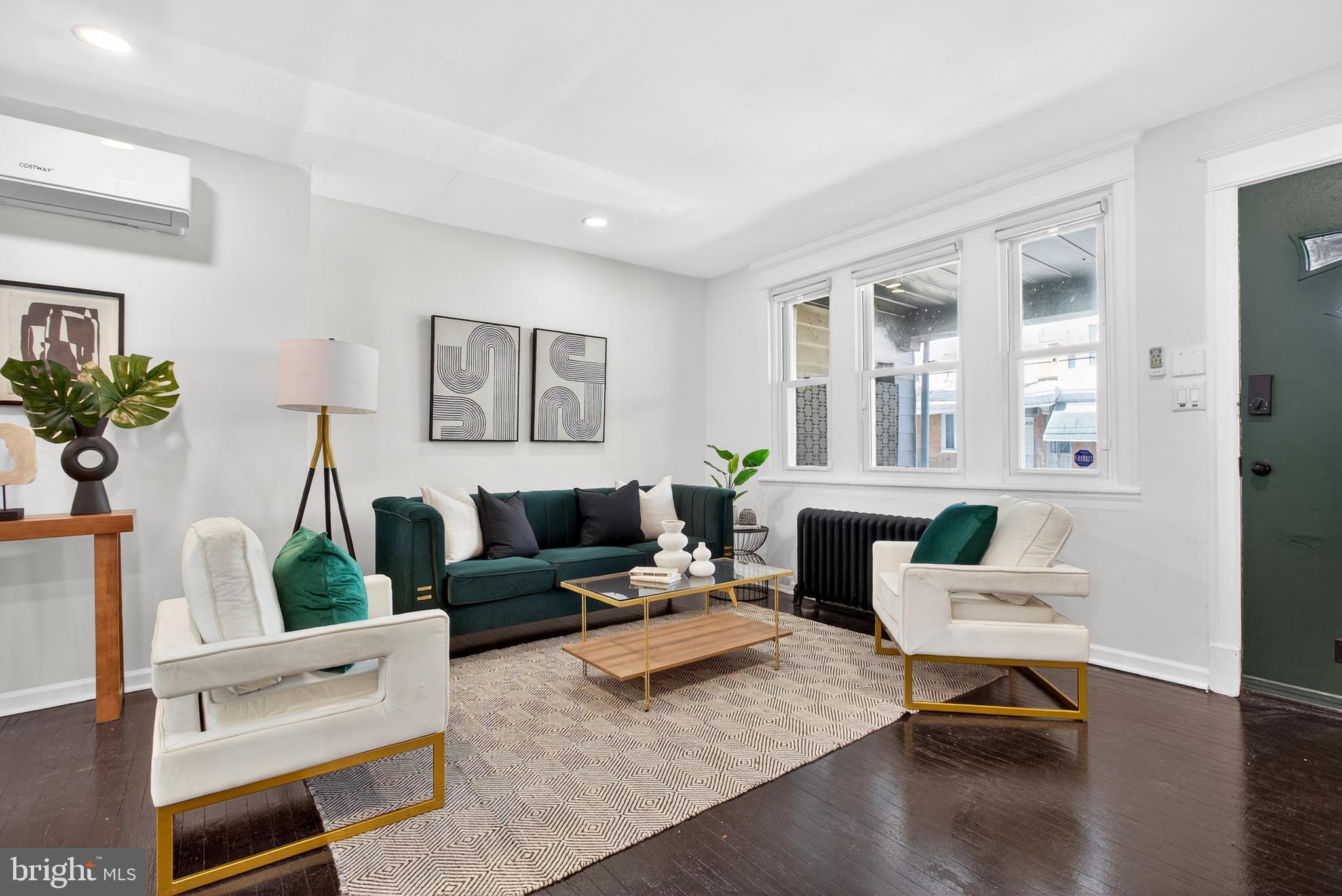**$5,000 SELLER ASSIST OFFERED!!** Welcome to 128 E Tulpehocken Street! This beautifully renovated 3-bedroom / 2.5 bathroom  East Germantown row home blends modern upgrades with thoughtful design throughout. Step up to the inviting front porch and into the open-concept main level, where hardwood floors and recessed lighting create a warm, contemporary feel. The spacious living area flows seamlessly into the dining space, perfect for entertaining or relaxing at home, and is complemented by a stylish powder room. A convenient under-stair closet offers flexible storage as a pantry or coat closet. The kitchen is a true highlight, featuring porcelain tile floors, stainless steel appliances, quartz countertops with ample workspace, shaker-style cabinets and a tasteful ceramic tile backsplash. Just off the kitchen, a private balcony provides the perfect spot for your morning coffee or a quiet evening unwind. Upstairs, you’ll find 3 bedrooms. The rear bedroom offers generous space and ample closet storage, while the middle bedroom is ideal for guests, a nursery, or a home office. The full hall bathroom showcases a modern vanity, porcelain tile flooring, a subway-tiled tub/shower combo, and a classic Philadelphia skylight that fills the space with natural light. The primary suite, located at the front of the home, features a bright, spacious layout and an ensuite bathroom with a subway-tiled stall shower, tiled floors, and a sleek vanity. The fully finished walkout basement is perfect for a media room, gym, or office and provides direct access to the rear patio and one-car garage. Additional highlights include hardwood flooring throughout, recessed lighting, stainless steel appliances, and a new 4-zone mini-split system for efficient, customizable comfort.  Schedule your showing today!!