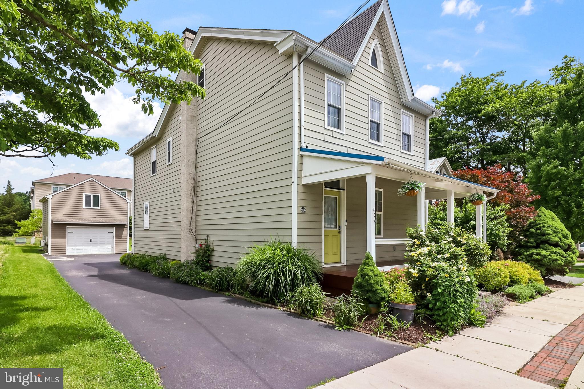 This charming home offers three spacious bedrooms and four bathrooms, including three full baths and one half bath. A major renovation completed in 2014 transformed the property with modern updates while preserving its historic character. The heart of the home features a beautifully appointed kitchen with granite countertops, pendant lighting, and bar seating that flows seamlessly into the dining area in an inviting open-concept layout. Adjacent to the kitchen, the living room showcases stunning original wide plank flooring that adds warmth and authenticity. Step outside to enjoy the south-facing front porch, perfect for relaxing, along with a wrap-around covered porch that offers side and rear views for outdoor entertaining. Above the detached two-car garage sits a versatile bonus room complete with a kitchenette and full bathroom, ideal for guests or a private retreat. Central air conditioning ensures year-round comfort throughout the entire property. This thoughtfully renovated residence combines classic appeal with contemporary conveniences in a prime Elverson location.