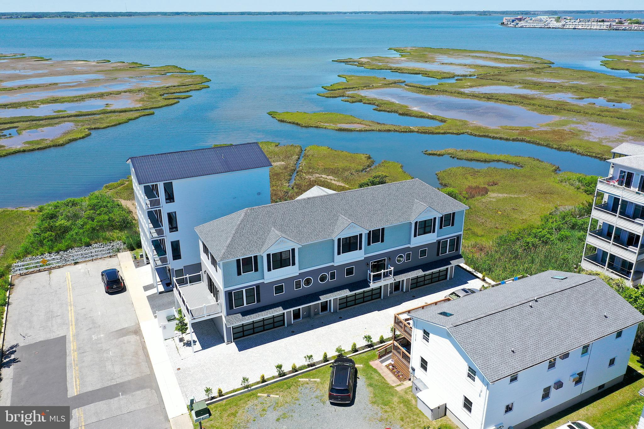 Rare opportunity to own all three brand-new luxury townhomes in one of Ocean City's most desirable bayside locations. Offered together as a package, this unique investment includes three beautifully crafted residences, each featuring stunning bay views, high-end custom finishes, and thoughtful design throughout. Built by a respected local custom builder, every unit offers expansive living spaces, conditioned garages with striking glass garage doors, and water views from each unit. 
Located on a short bay block from the bay and an easy walk to the beach, owners and guests will appreciate access to a quieter, low-density stretch of shoreline without the crowds. The prime location places you close to restaurants, entertainment, shopping, and everything Ocean City has to offer while maintaining a more relaxed coastal atmosphere. With no HOA or condo fees, ownership is simple and cost-effective. The property also presents tremendous rental income potential—rent all three units or keep one for personal use while generating income from the other two. Whether you're seeking a premier investment property, family compound, corporate retreat, or luxury coastal getaway, opportunities like this are exceptionally rare.
Three brand-new townhomes. Bay views from every unit. No HOA or condo fees. Endless possibilities.