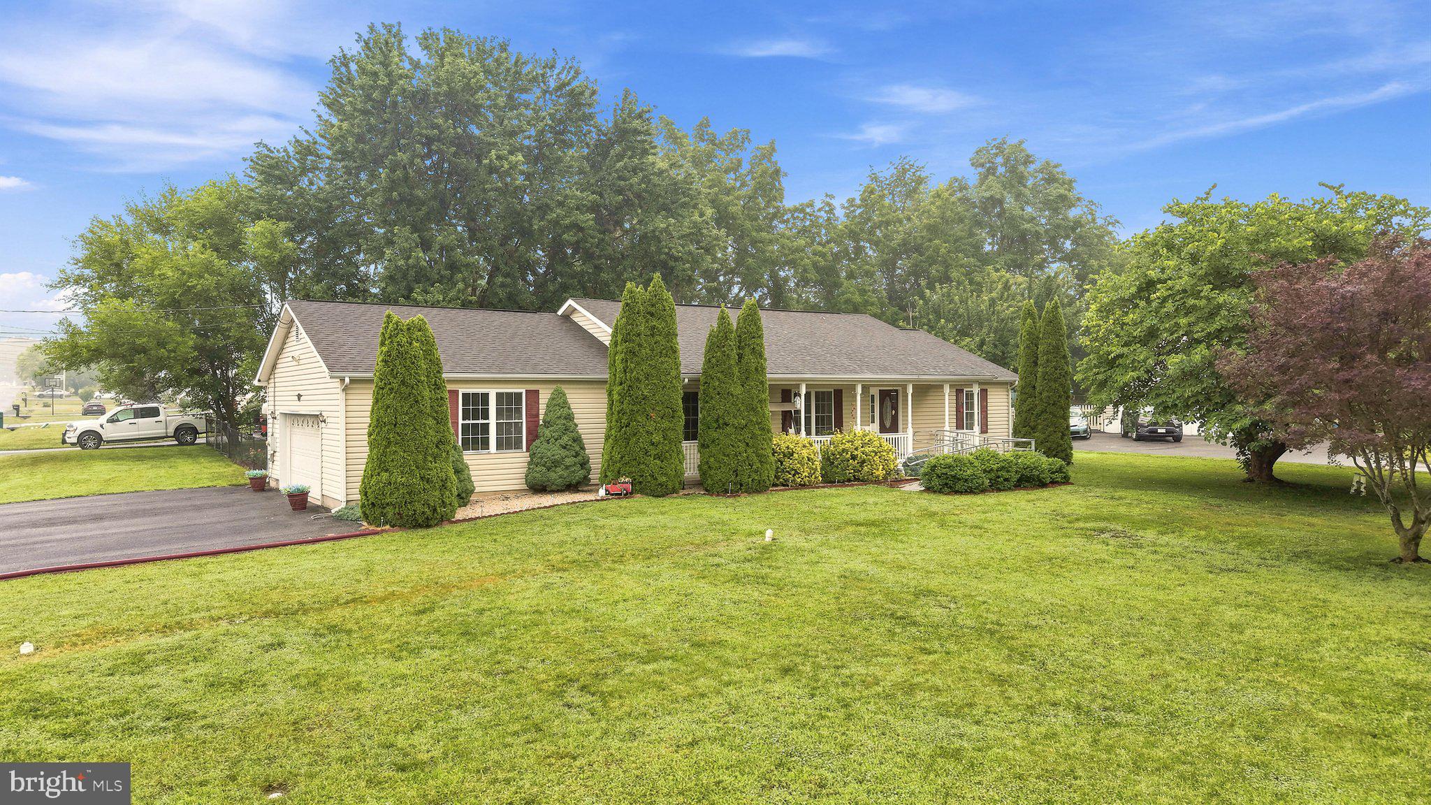 IMMACULATE RANCHER ON HUGE LEVEL LOT IN ELIZABETH STATION! This beautifully maintained 3-bedroom, 2-bath ranch home offers comfortable one-level living on a spacious 0.60-acre level lot with a fenced rear yard in a convenient commuter location just minutes from I-81. Freshly painted in today's neutral colors, the home features a desirable split-bedroom floor plan, hardwood flooring throughout the main living areas, and chair rail detailing throughout much of the home. The spacious living room flows into the dining area with direct access to the rear deck, creating the perfect space for indoor and outdoor entertaining. The bright kitchen offers stainless steel appliances, abundant cabinetry, and pantry. The generously sized primary suite features a large walk-in closet and private bath, while the updated hall bath boasts a beautiful tiled walk-in shower. The oversized two-car garage is a hobbyist's dream with epoxy flooring, built-in shelving, workbench, attic accessible storage, electric door openers, and wiring for an air compressor. A convenient laundry/mudroom includes the washer and dryer, utility sink, water softener, and additional storage. Outside, you'll love the enormous level front yard, peaceful rear deck overlooking the fenced backyard, and the impressive 10' x 20' storage shed for all your lawn equipment and outdoor toys. Move-in ready and offering easy access for commuters, this home combines comfort, functionality, and exceptional outdoor space in one fantastic package. Front and rear ADA accessible ramps convey.